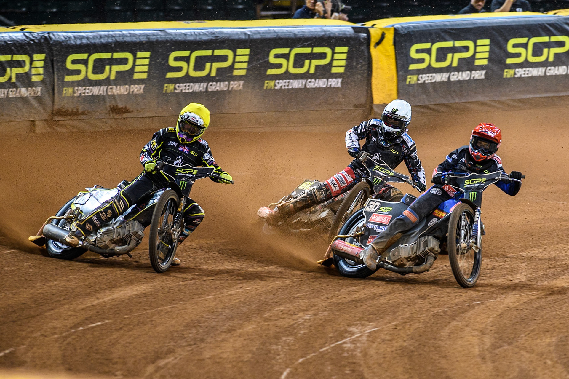 Tom Brennan (16) Wild card rider of Great Britain in Yellow rides outside Leon Madsen (30) of Denmark with Fredrik Lindgren (66) of Sweden in White behind during the FIM Speedway Grand Prix of Great Britain at The Principality Stadium, Cardiff on Saturday 17th August 2024. (Photo: Ian Charles | MI News)