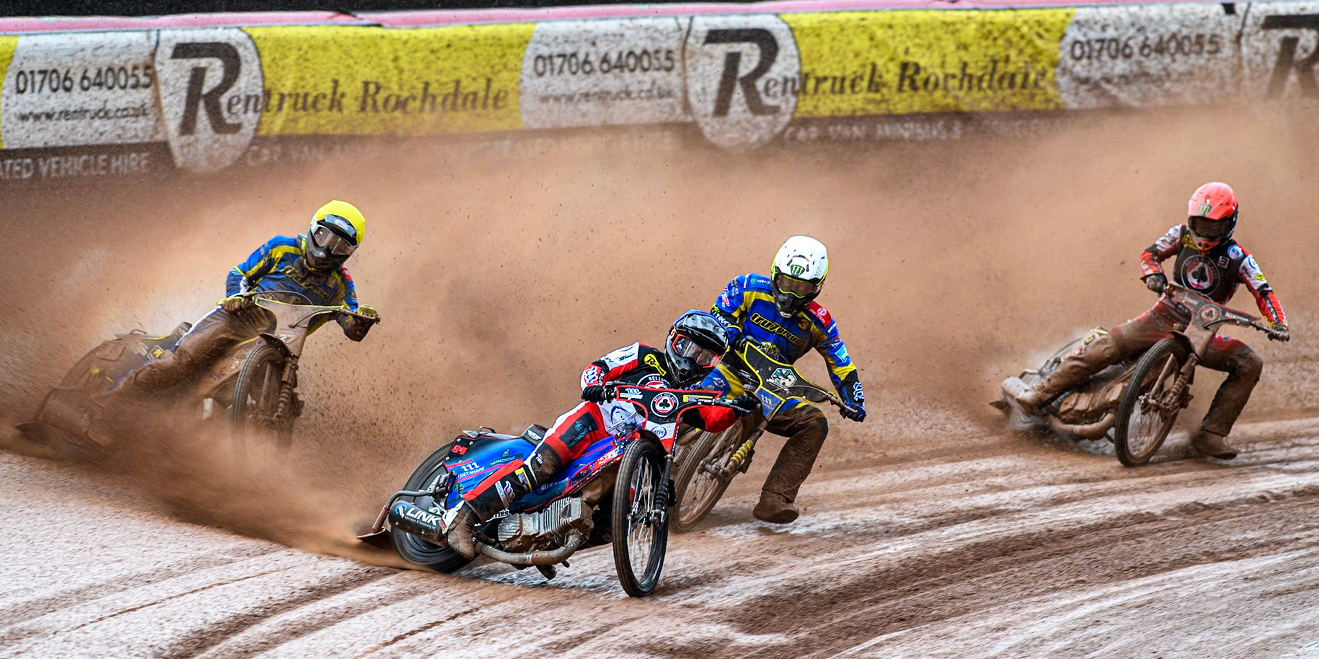 Belle Vue Aces' Ben Cook in Blue leading Chris Holder in White, Sheffield Tigers' Guest rider Tom Brennan in Yellow and Belle Vue Aces' Jaimon Lidsey in Red during the Rowe Motor Oil Premiership match between Belle Vue Aces and Sheffield Tigers at the National Speedway Stadium, Manchester on Monday 27th May 2024. (Photo: Ian Charles | MI News)