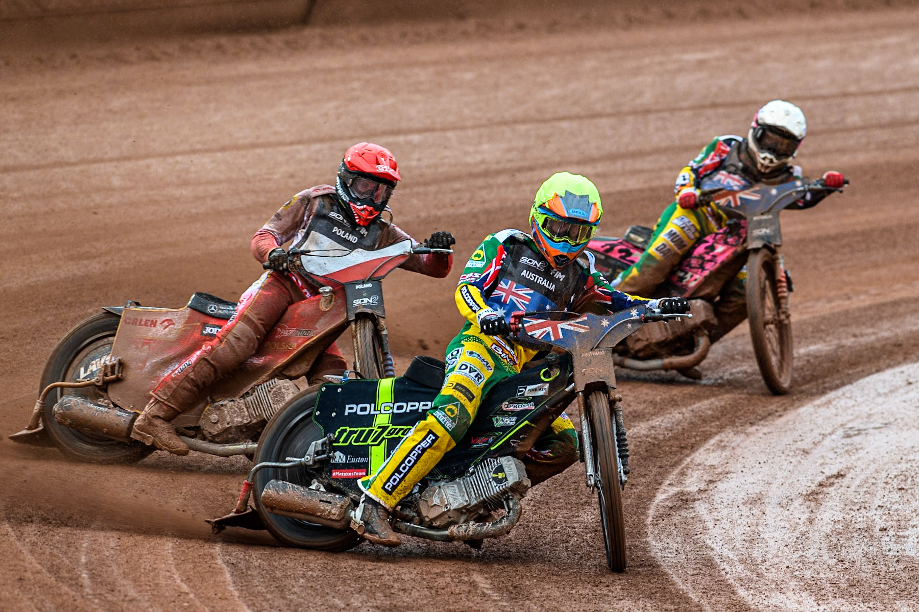 Keynan Rew of Australia in Yellow leading Wiktor Przyjemski of Poland in Red and James Pearson of Australia in White during the Monster Energy FIM Speedway of Nations 2 (Under 21) Final at the National Speedway Stadium, Manchester on Friday 12th July 2024. (Photo: Ian Charles | MI News)