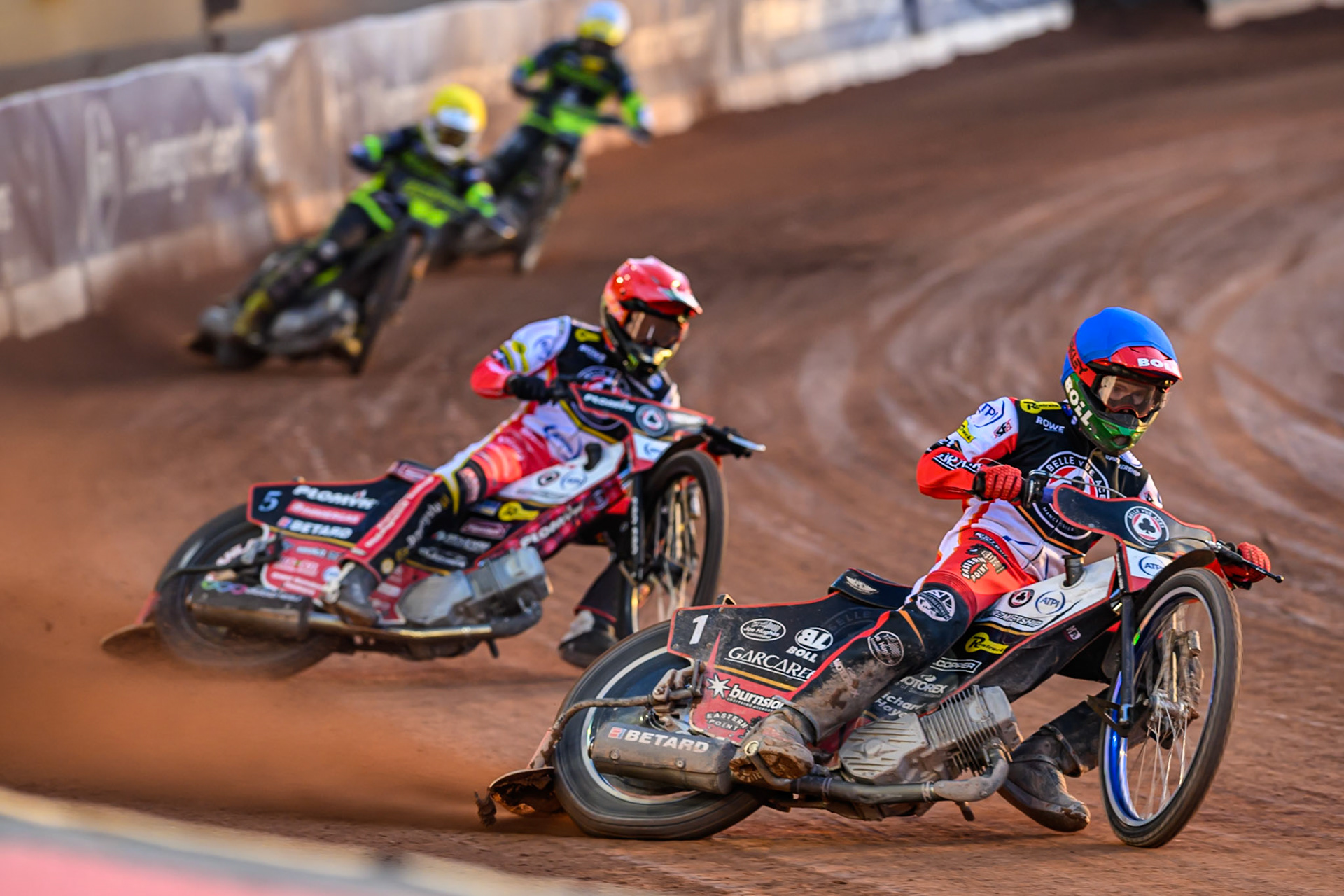 Brady Kurtz of Belle Vue Aces  in Blue and Dan Bewley of Belle Vue Aces  in Red leading Tom Brennan of Ipswich Witches  in Yellow and Adam Ellis of Ipswich Witches  in White during the Rowe Motor Oil Premiership match between Belle Vue Aces and Ipswich Witches at the National Speedway Stadium, Manchester on Monday 4th August 2025. (Photo: Ian Charles | MI News)