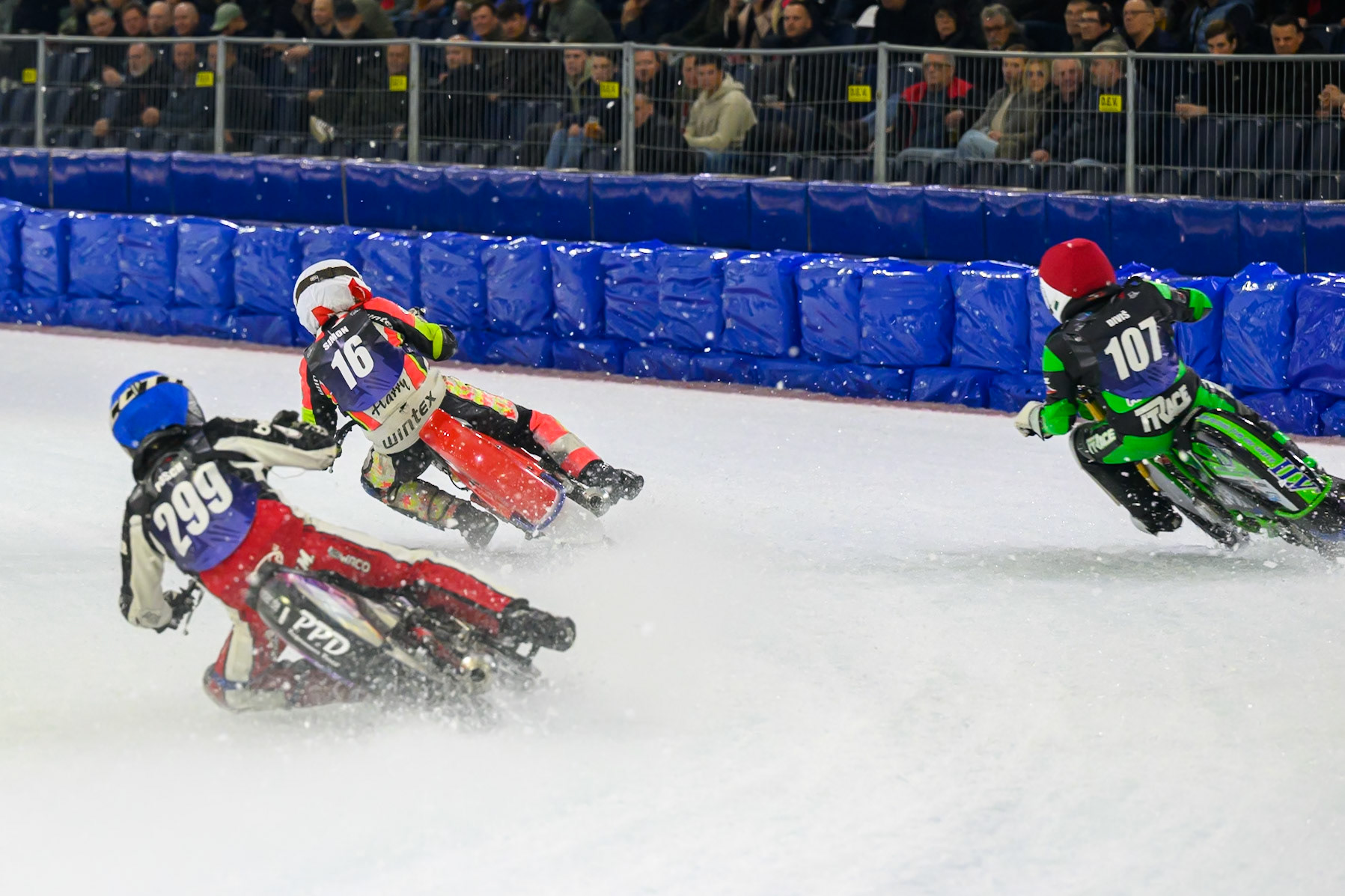 Martin Posch (299) of Austria in Blue chases Andrej Divis (107) of Czechia in Red and Wild Card Harald Simon (16) of Austria  in White during the FIM Ice Speedway Gladiators World Championship Final 3 at Ice Rink Thialf, Heerenveen on Saturday 11th April 2026. (Photo: Ian Charles | MI News)