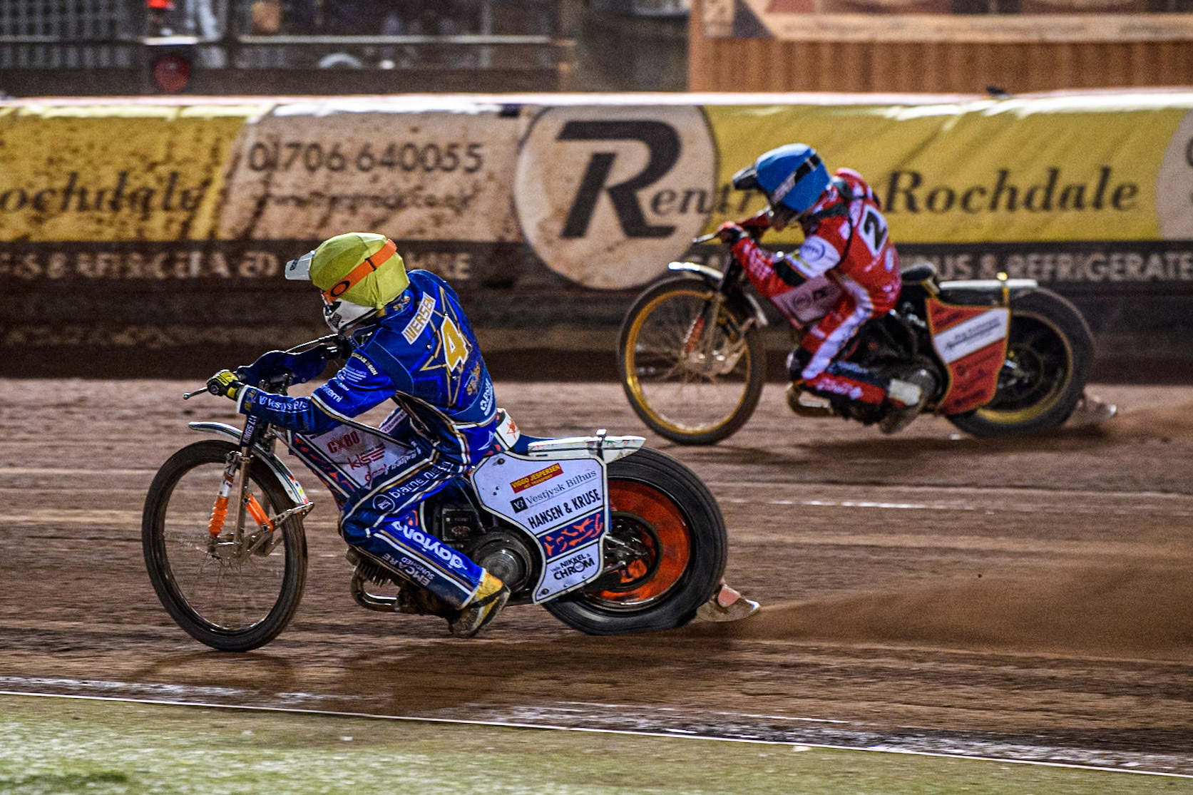 Niels-Kristian Iversen of Kings Lynn Stars in Yellow rides inside Norick Blödorn of Belle Vue Aces in Blue during the Rowe Motor Oil Premiership match between Belle Vue Aces and King's Lynn Stars at the National Speedway Stadium, Manchester on Monday 5th April 2025. (Photo: Ian Charles | MI News)