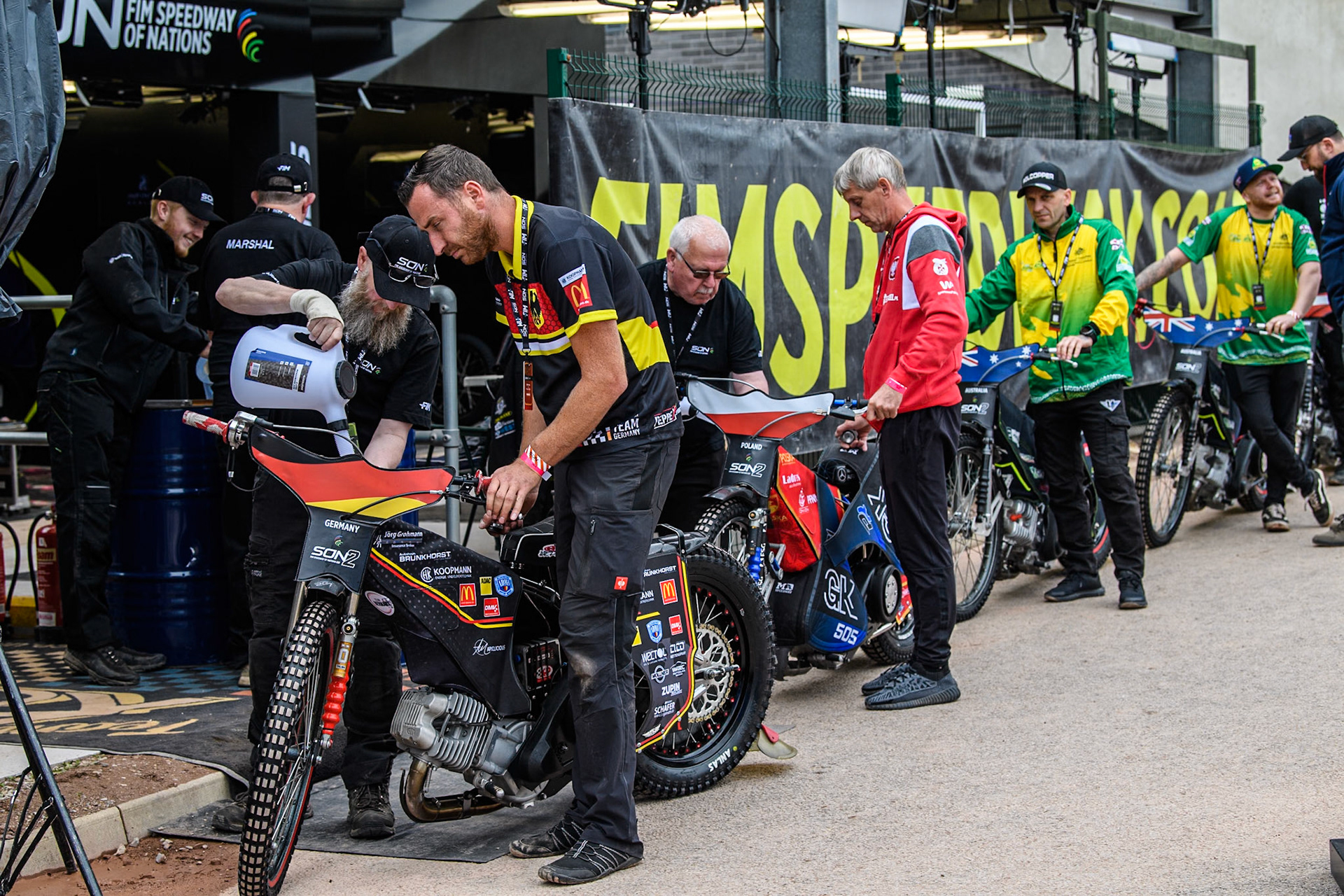 The mechanics line up to fuel the bikes before practice during the Monster Energy FIM Speedway of Nations 2 (Under 21) Final at the National Speedway Stadium, Manchester on Friday 12th July 2024. (Photo: Ian Charles | MI News)