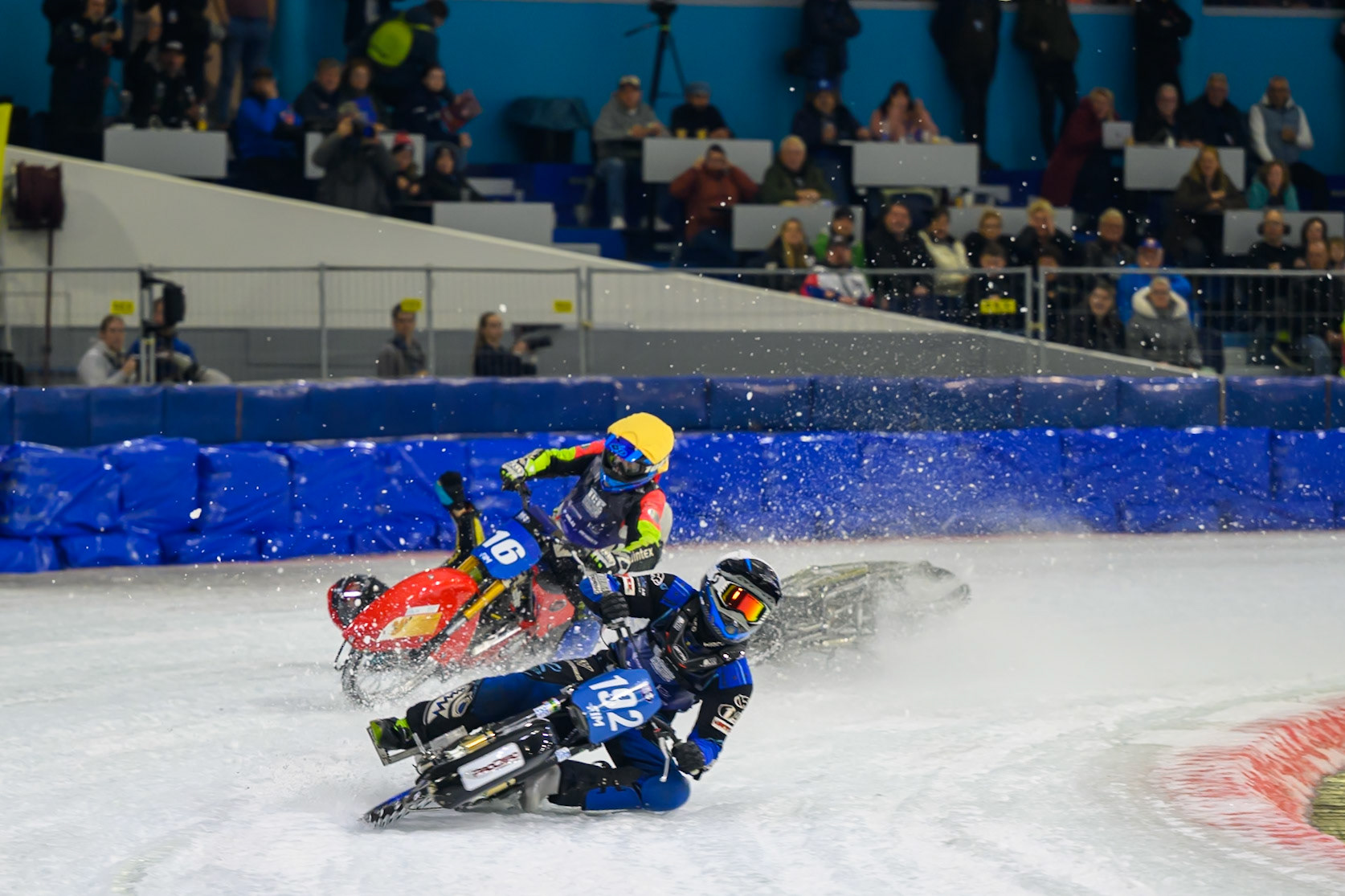 Heikki Huusko (67) of Finland  collides with Wild Card Harald Simon (16) of Austria in Yellow in the first turn during the FIM Ice Speedway Gladiators World Championship Final 3 at Ice Rink Thialf, Heerenveen on Saturday 11th April 2026. (Photo: Ian Charles | MI News)