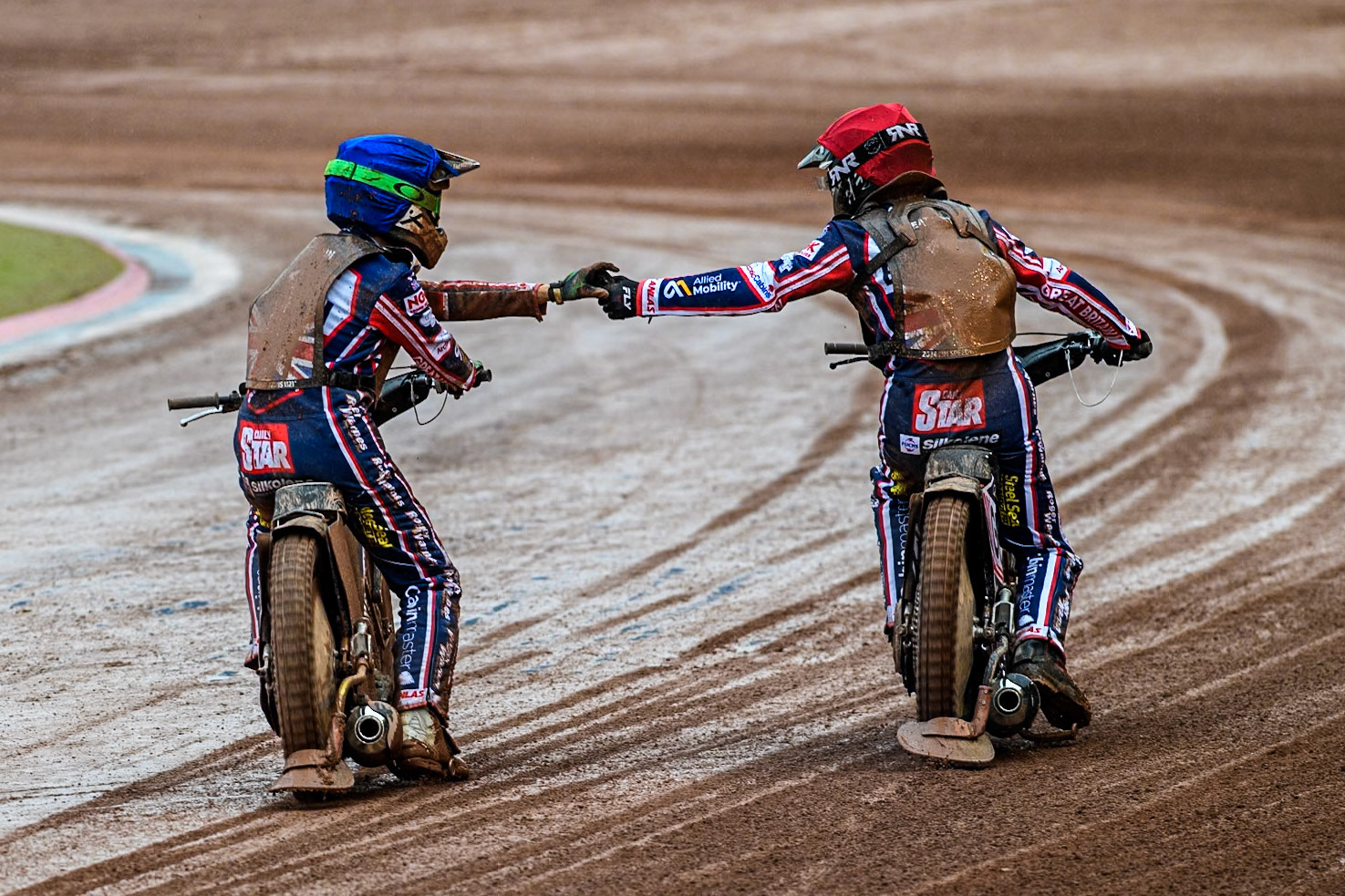 The GB riders Leon Flint in Blue and Dan Thompson in Red celebrate their second heat win during the Monster Energy FIM Speedway of Nations 2 (Under 21) Final at the National Speedway Stadium, Manchester on Friday 12th July 2024. (Photo: Ian Charles | MI News)