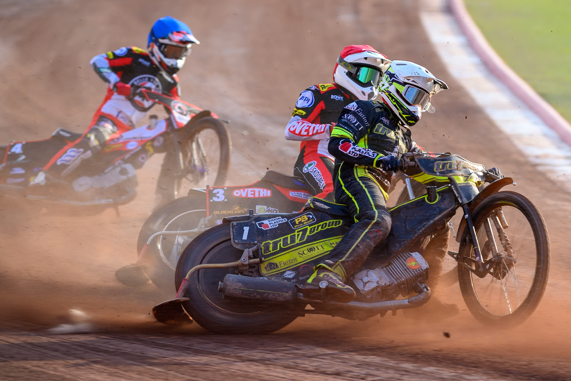 Tom Brennan of Ipswich Witches in White leading Peter Kildemand of Belle Vue Aces in Red and Zach Cook of Belle Vue Aces in Blue during the Rowe Motor Oil Premiership match between Belle Vue Aces and Ipswich Witches at the National Speedway Stadium, Manchester on Saturday 20th June 2026. (Photo: Ian Charles | MI News)