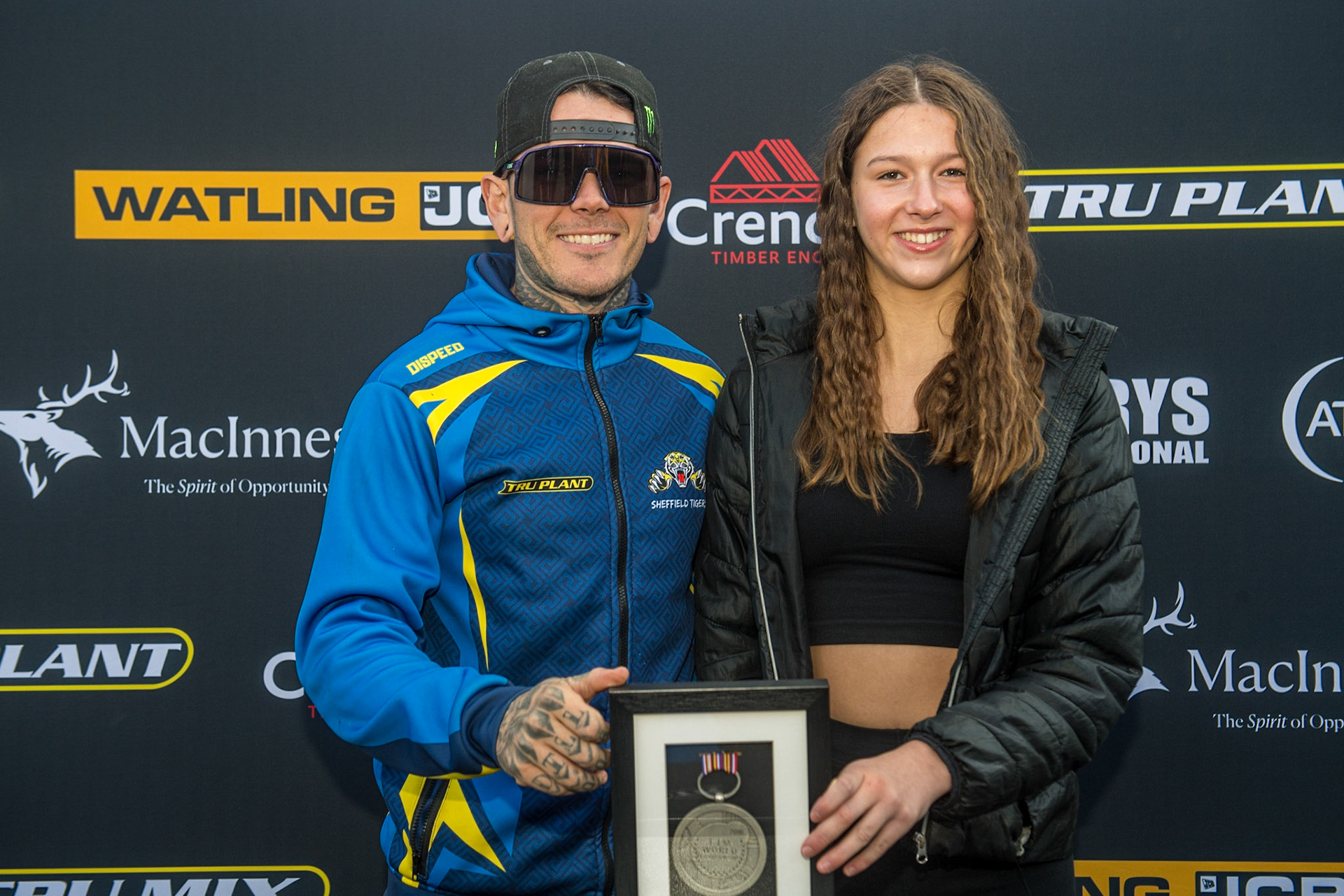 Tai Woffinden (left) meets Isobel Battersby. The last time they met was at the 2016 World Cup Final when Tai gave Isobel his silver medal. Since then she had the medal framed, and met him on his 2023 debut for the Sheffield Tigers during the Sports Insure Premiership match between Belle Vue Aces and Sheffield Tigers at the National Speedway Stadium, Manchester on Monday 7th August 2023. (Photo: Ian Charles | MI News)