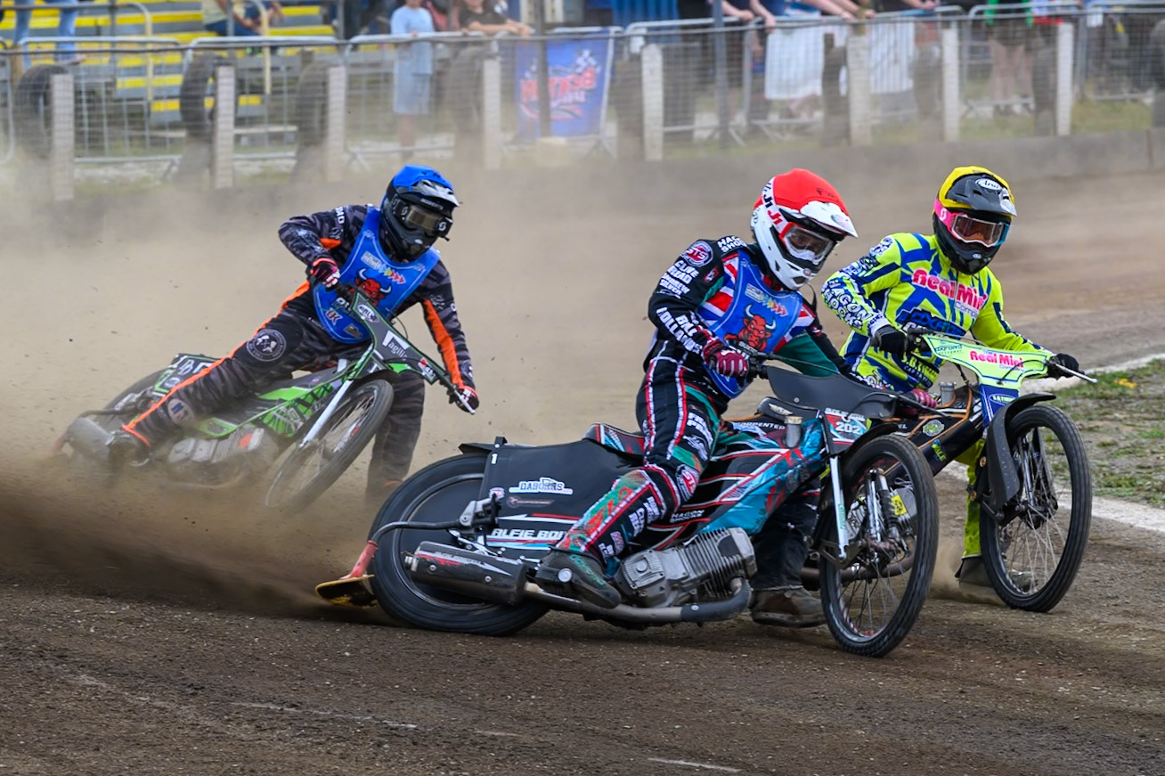 Alfie Bowtell of Buxton Bulls in Red leading Ashton Vale of Oxford Chargers in Yellow  and Jack Roberts of Buxton Bulls in Blue during the WSRA National Development League match between Buxton Bulls and Oxford Chargers at Hi-Edge Speedway, Buxton on Sunday 2nd August 2026. (Photo: Ian Charles | MI News)
