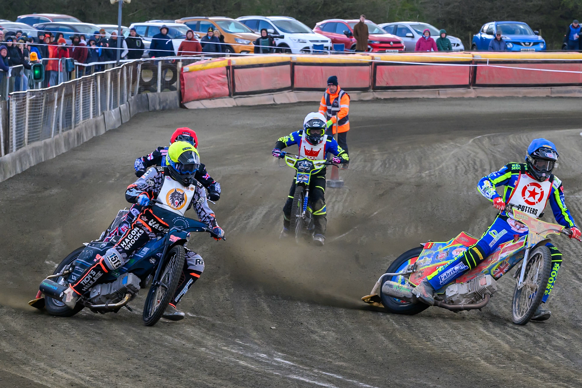 Simon Lambert of 'The Potters'  in Blue rides inside Jack Kingston of 'The Wolves' in Yellow with Jack Shimelt of Buxton Bulls  in Red and Harrison Rogers of 'The Potters'  in White behind during the Regina Chains Fours at Buxton Speedway, Buxton on Sunday 5th April 2026. (Photo: Ian Charles | MI News)