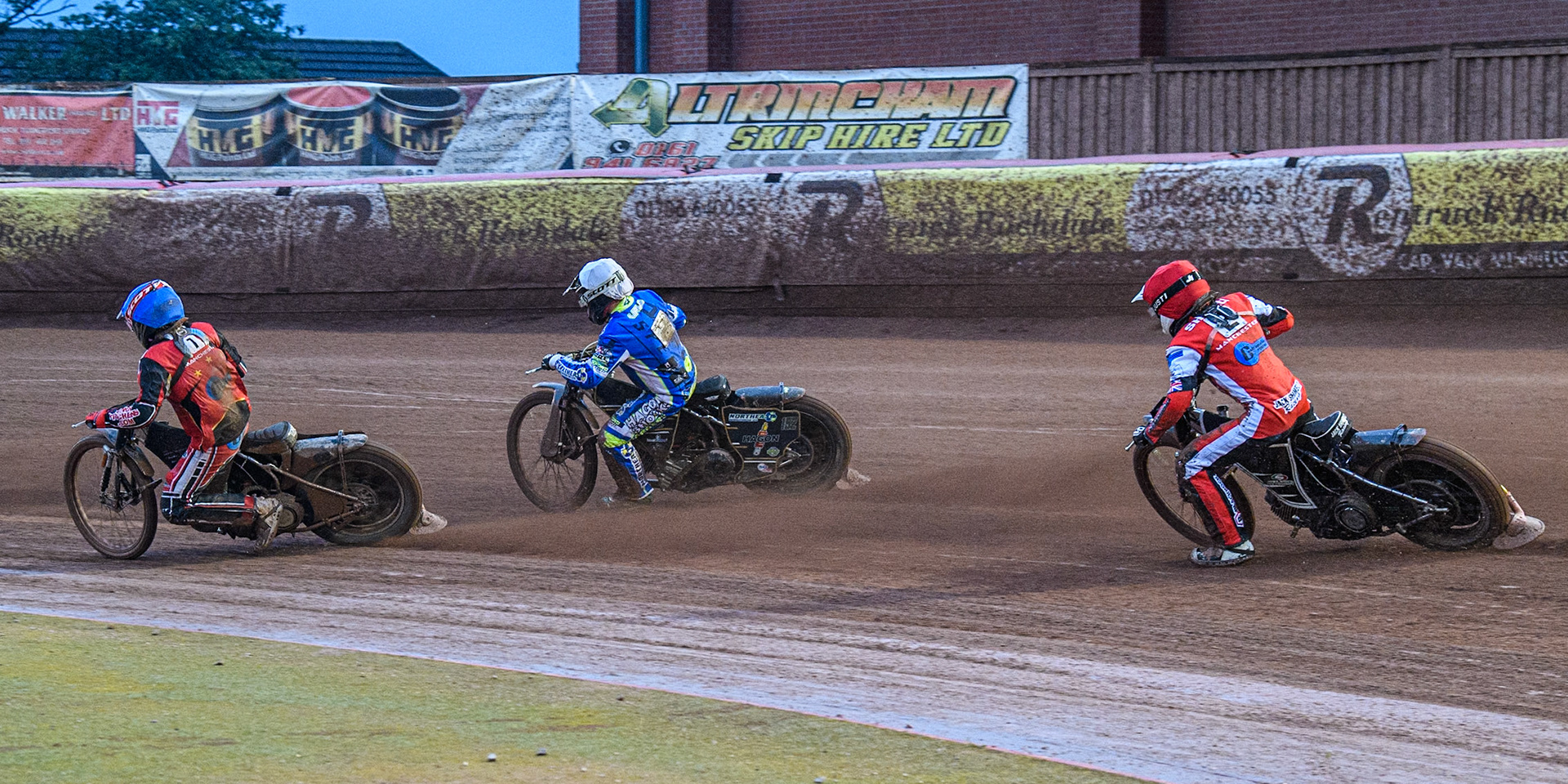 Belle Vue Colts' Jack Shimelt  in Red chases Oxford Chargers' Ashton Vale  in White and Belle Vue Colts' Harry McGurk  in Blue during the WSRA National Development League match between Belle Vue Colts and Oxford Chargers at the National Speedway Stadium, Manchester on Friday 2nd August 2024. (Photo: Ian Charles | MI News)