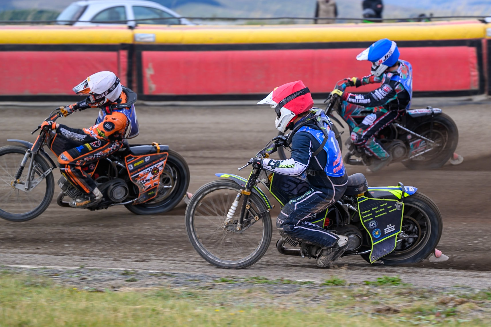 Nathan Ablitt, Guest Rider for Buxton Bulls in Red  and Alfie Bowtell of Buxton Bulls in Blue  chase Mickie Simpson of Kings Lynn Young Stars in White during the WSRA National Development League match between Buxton Bulls and King's Lynn Young Stars at Hi-Edge Speedway, Buxton on Sunday 9th August 2026. (Photo: Ian Charles | MI News)