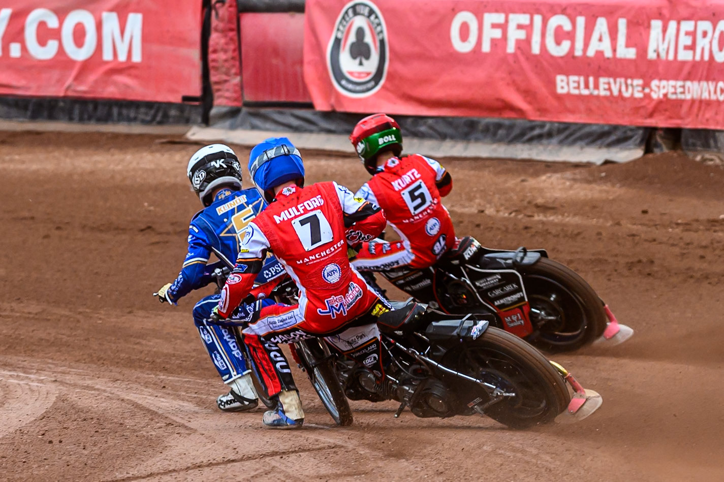 Belle Vue Aces' Jake Mulford in Blue chases Kings Lynn Stars' Nicolai Klindt in White and Belle Vue Aces' Brady Kurtz in Red during the Rowe Motor Oil Premiership match between Belle Vue Aces and King's Lynn Stars at the National Speedway Stadium, Manchester on Monday 23rd June 2025. (Photo: Ian Charles | MI News)