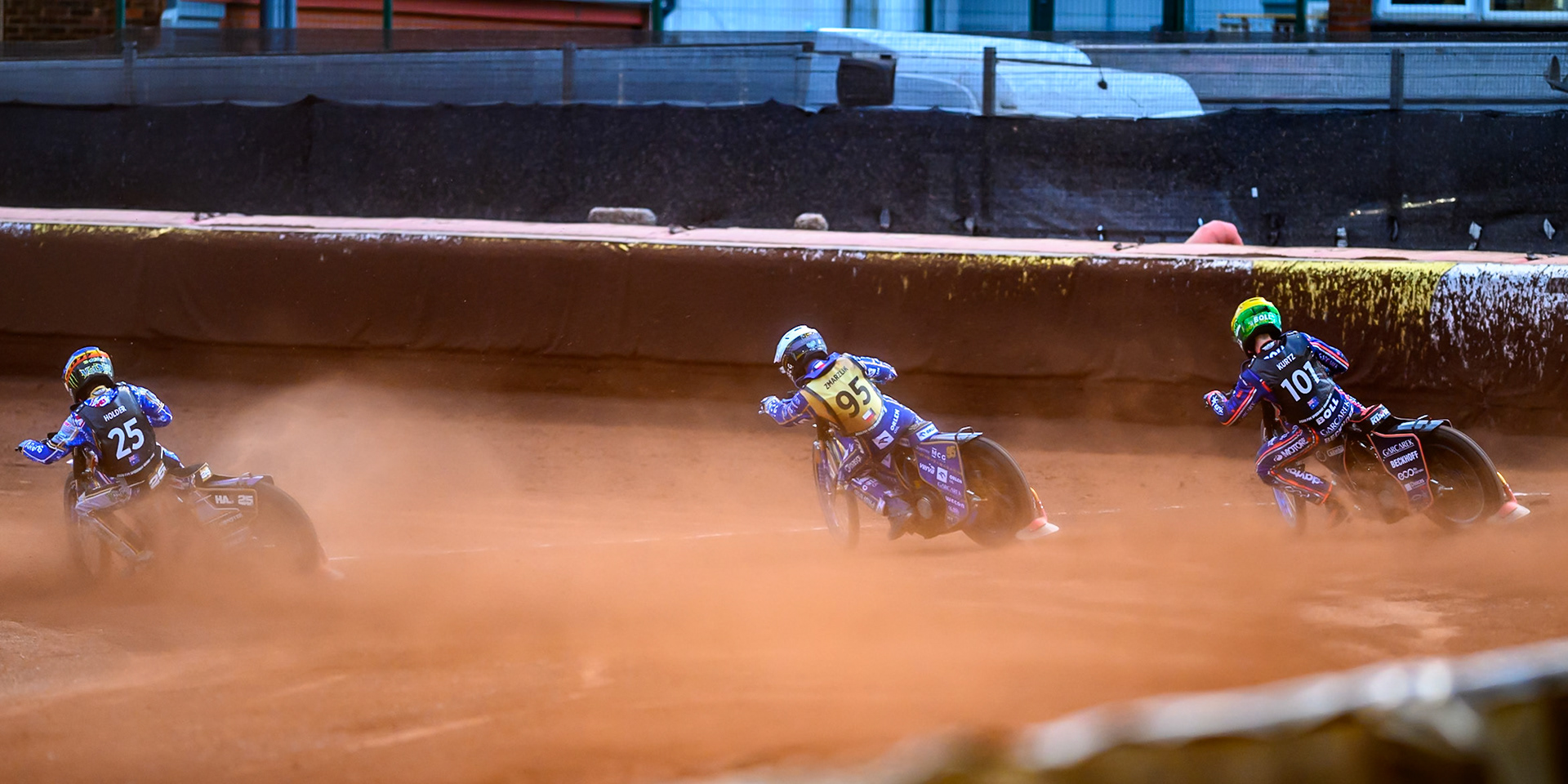 Jack Holder (25) of Australia in Blue on the inside of Bartosz Zmarzlik (95) of Poland in White and Brady Kurtz (101) of Australia in Yellow as they hit the first turn in the final during the ATPI  FIM Speedway GP of Manchester at the National Speedway Stadium, Manchester on Saturday 6th June 2026. (Photo: Ian Charles | MI News)