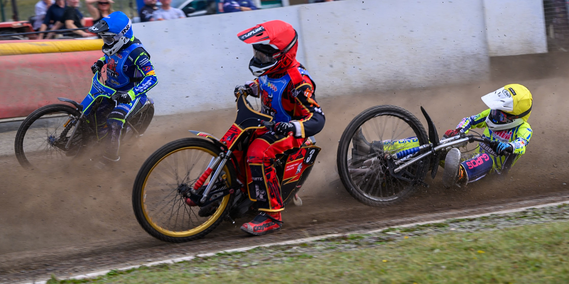 Harry Fletcher of Oxford Chargers in Yellow  falls behind Luke Harris of Buxton Bulls in Red  and Arran Butcher of Buxton Bulls in Blue  during the WSRA National Development League match between Buxton Bulls and Oxford Chargers at Hi-Edge Speedway, Buxton on Sunday 2nd August 2026. (Photo: Ian Charles | MI News)