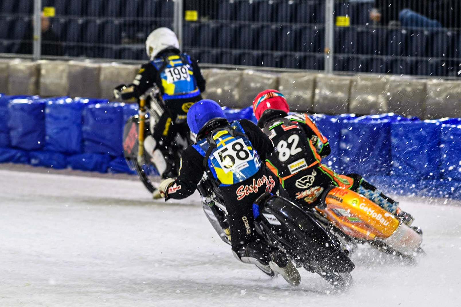 Sweden's Stefan Svensson (58) in Blue and Germany's Markus Jell (82) in Red chase Sweden's Martin Haarahiltunen (199)  in White during the FIM Ice Speedway Gladiators World Championship Final 3 at Ice Rink Thialf, Heerenveen on Saturday 6th April 2024. (Photo: Ian Charles | MI News)