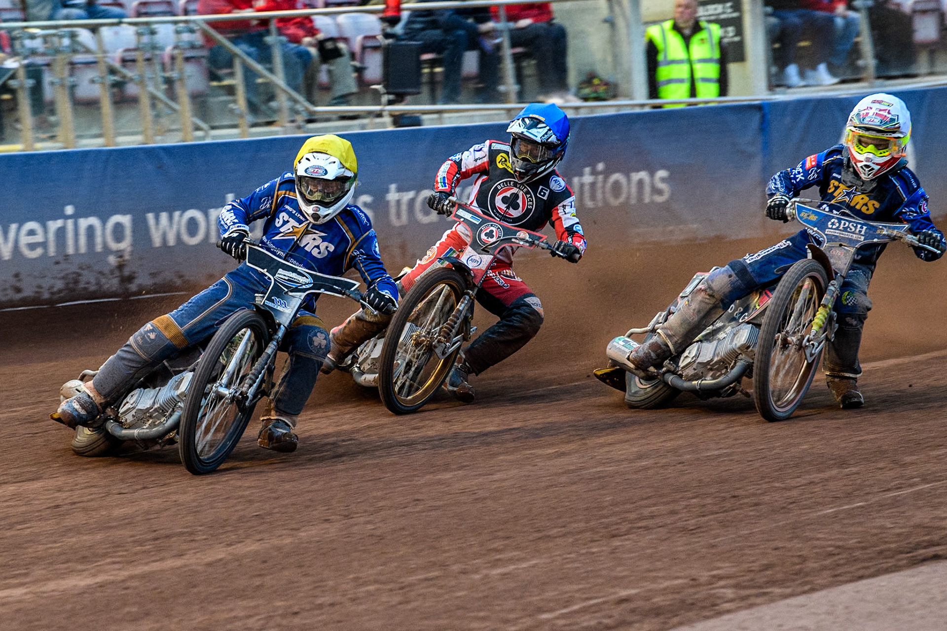 King Lynn Stars' Guest Richard Lawson in Yellow leading Belle Vue Aces' Connor Mountain in Blue and King Lynn Stars' Michael Palm Toft in White during the Rowe Motor Oil Premiership match between Belle Vue Aces and King's Lynn Stars at the National Speedway Stadium, Manchester on Monday 20th May 2024. (Photo: Ian Charles | MI News)