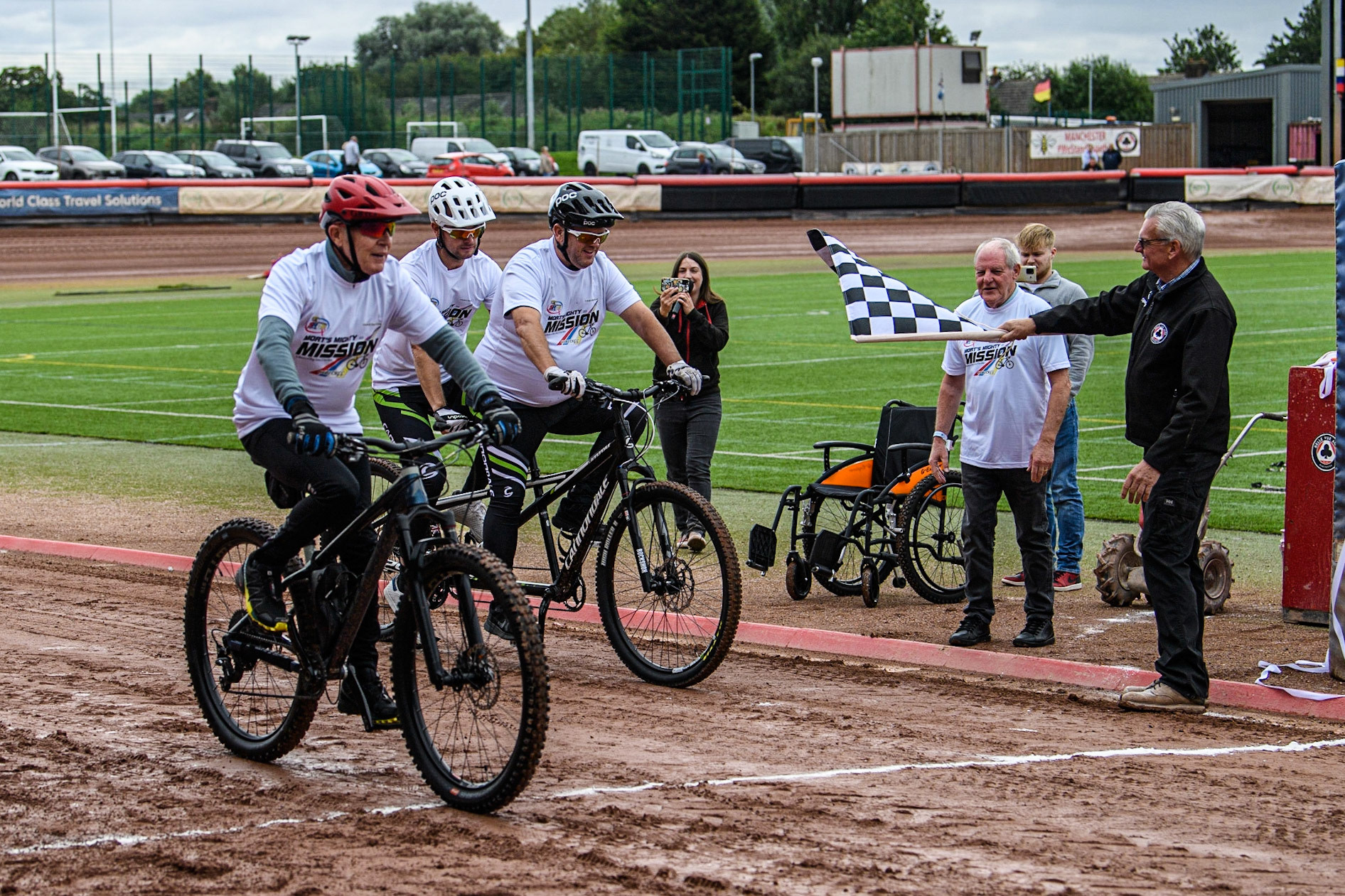 Former Belle Vue Rider Chris Morton (nearest Camera) together with former rider Ricky Ashworth and his tandem pilot, Dad Dave, on ‘Mort’s Mighty Mission’, to ride to the Principality Stadium Cardiff, in aid of the Speedway Riders Benevolent Fund. They finish their two laps of the Belle Vue track during the Sports Insure Premiership match between Belle Vue Aces and Leicester Lions at the National Speedway Stadium, Manchester on Monday 28th August 2023. (Photo: Ian Charles | MI News)
