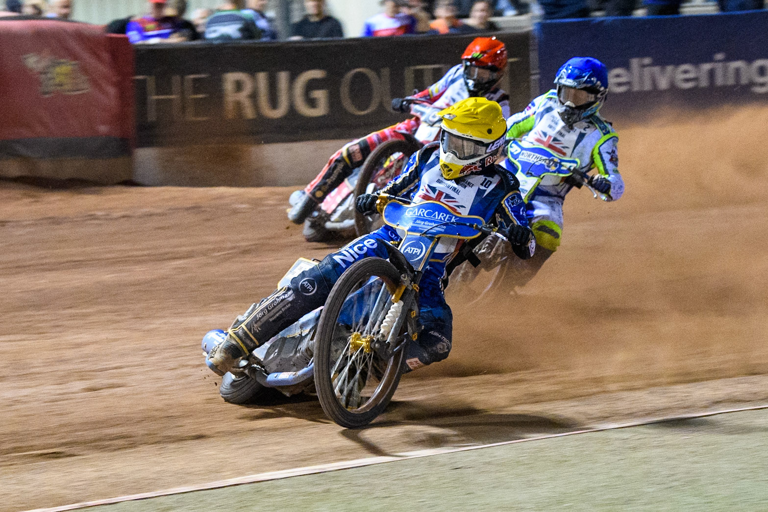 Robert Lambert in Yellow leading Chris Harris in Blue and Dan Bewley in Red during the Attis Insurance Sports Division British Final at the National Speedway Stadium, Manchester on Monday 12th May 2025. (Photo: Ian Charles | MI News)