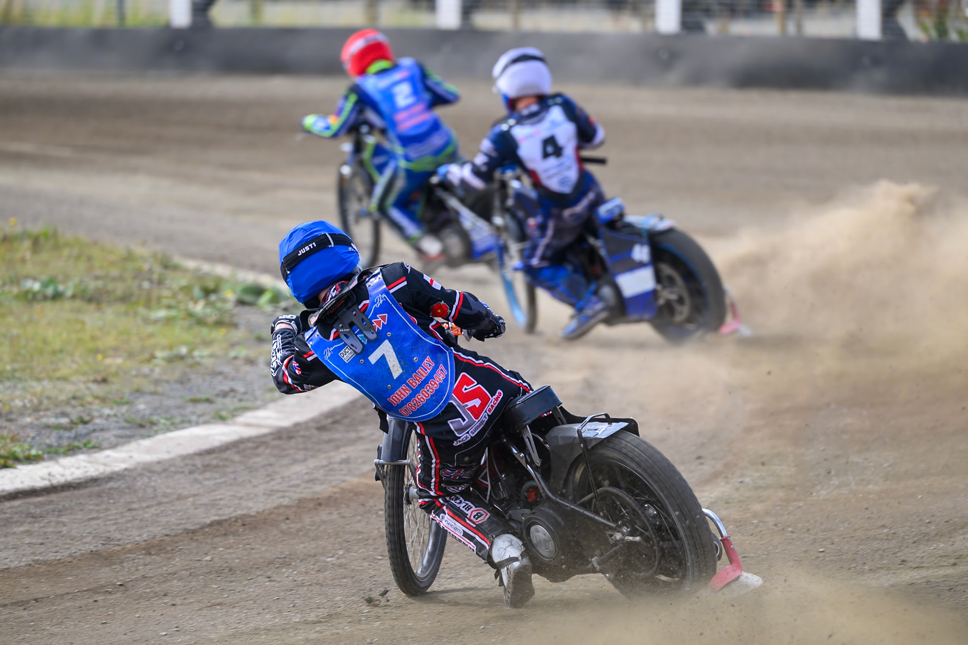 Jack Shimelt of Buxton Bulls in Blue chases Charlie Southwick of Middlesborough Tigers in White  and Arran Butcher of Buxton Bulls in Red during the WSRA National Development League match  between Buxton Bulls and Middlesborough Tigers at Hi-Edge Speedway, Buxton on Sunday 16th August 2026. (Photo: Ian Charles | MI News)