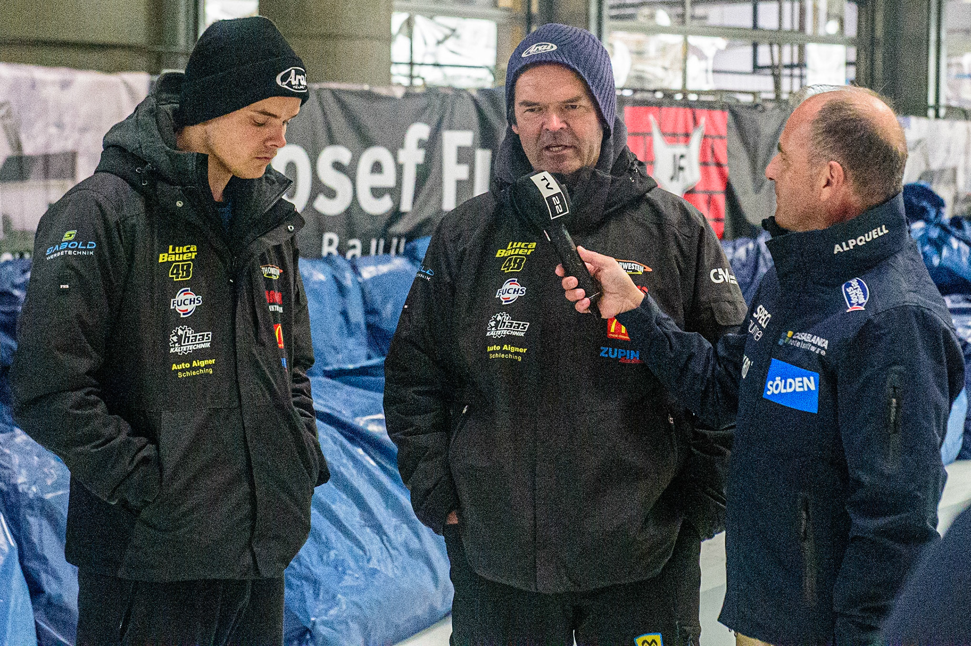 Luca Bauer (left) and father Gunther give an interview to Bavarian local TV during the Ice Speedway Gladiators World Championship Final 2 at Max-Aicher-Arena, Inzell, Germany on Sunday 19th March 2023. (Photo: Ian Charles | MI News)