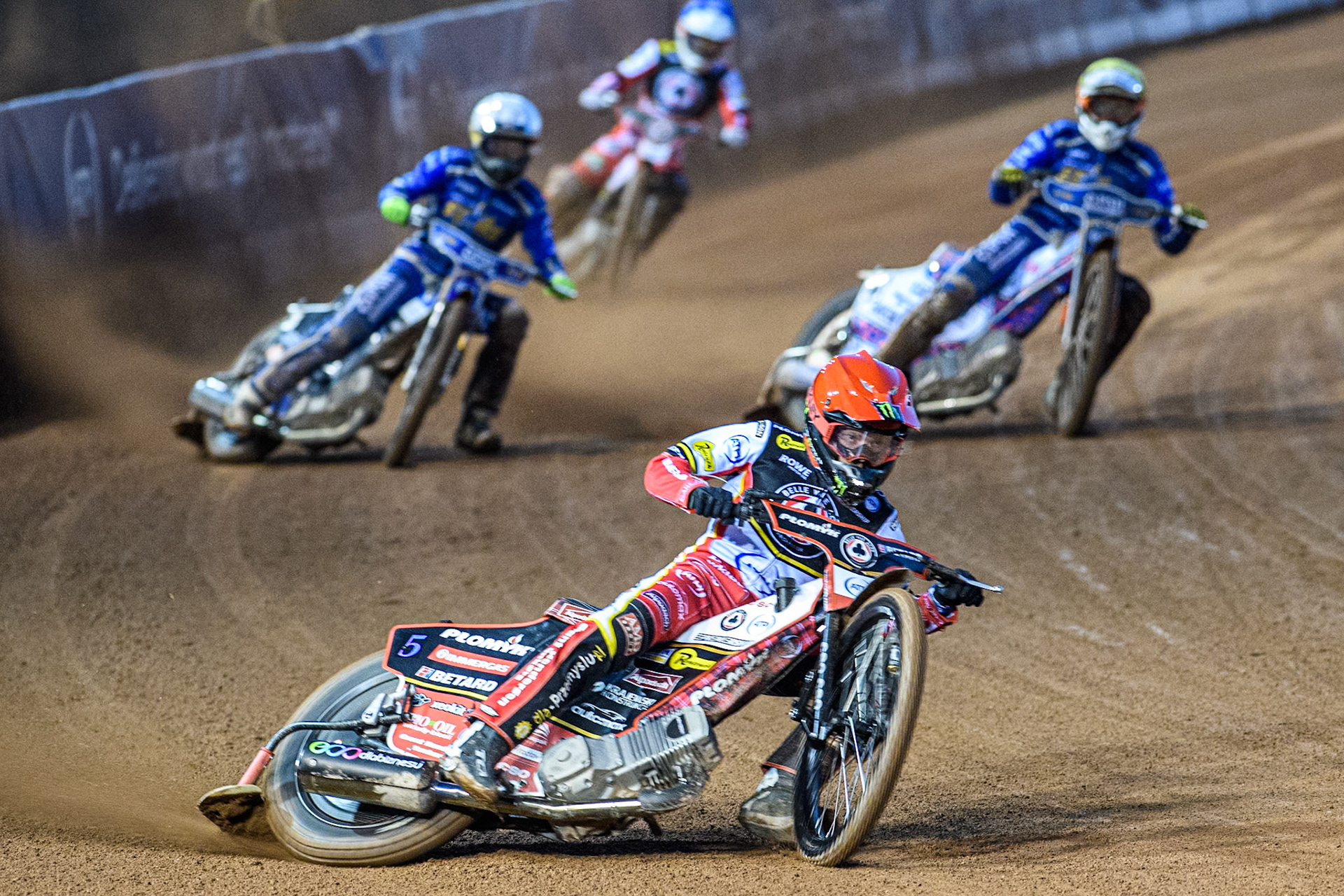 Dan Bewley of Belle Vue Aces in Red leading Nicolai Klindt of Kings Lynn Stars in White, Niels-Kristian Iversen of Kings Lynn Stars in Yellow and Tate Zischke of Belle Vue Aces in Blue during the Rowe Motor Oil Premiership match between Belle Vue Aces and King's Lynn Stars at the National Speedway Stadium, Manchester on Monday 5th April 2025. (Photo: Ian Charles | MI News)