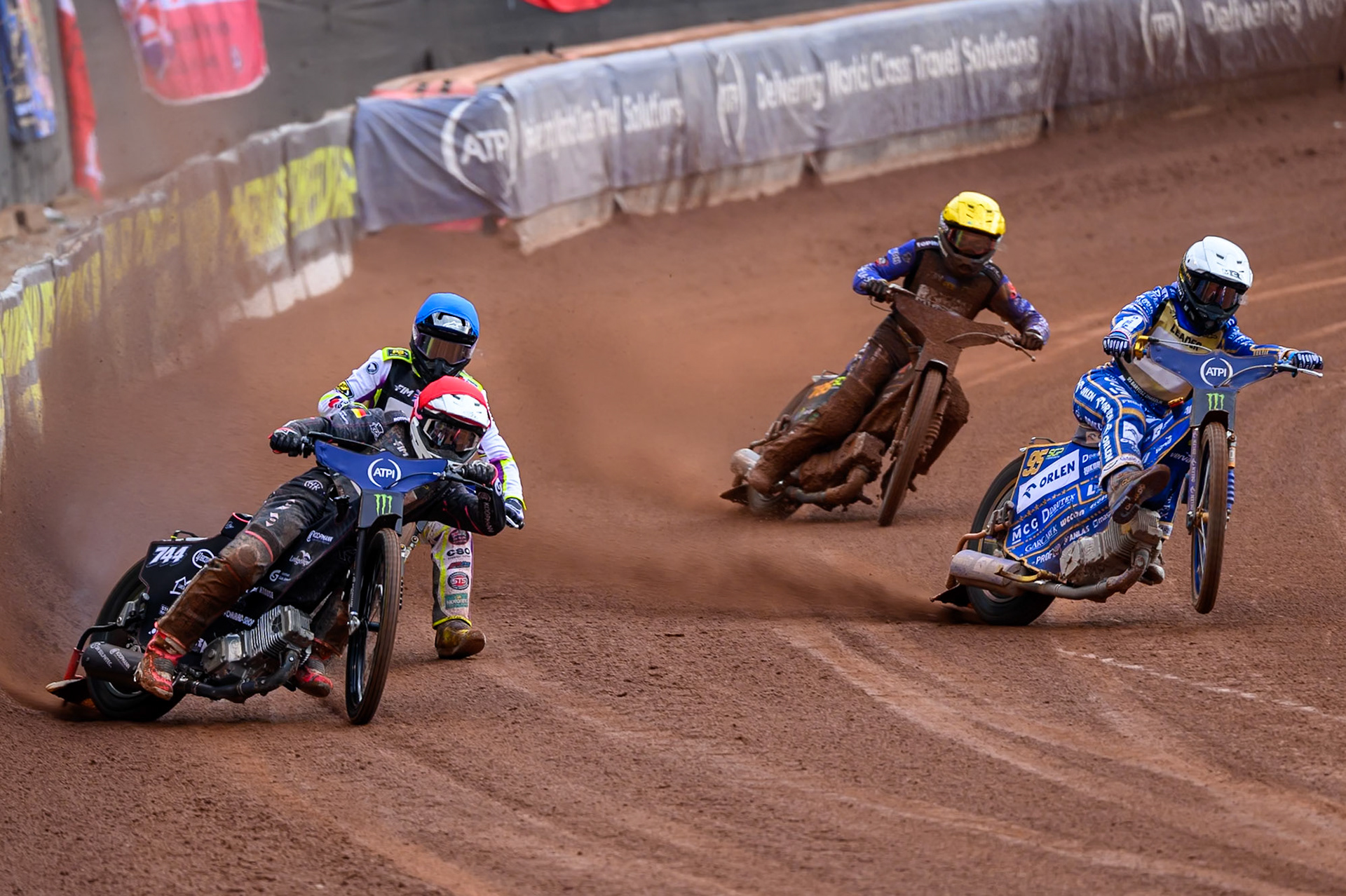 Kai Huckenbeck (744) of Germany in Red rides outside Bartosz Zmarzlik (95) of Poland in White with Wild Card Tom Brennan (16) of Great Britain in Blue and Nazar Parnitskyi (785) of Ukraine in Yellow behind during the ATPI  FIM Speedway GP of Manchester at the National Speedway Stadium, Manchester on Saturday 6th June 2026. (Photo: Ian Charles | MI News)