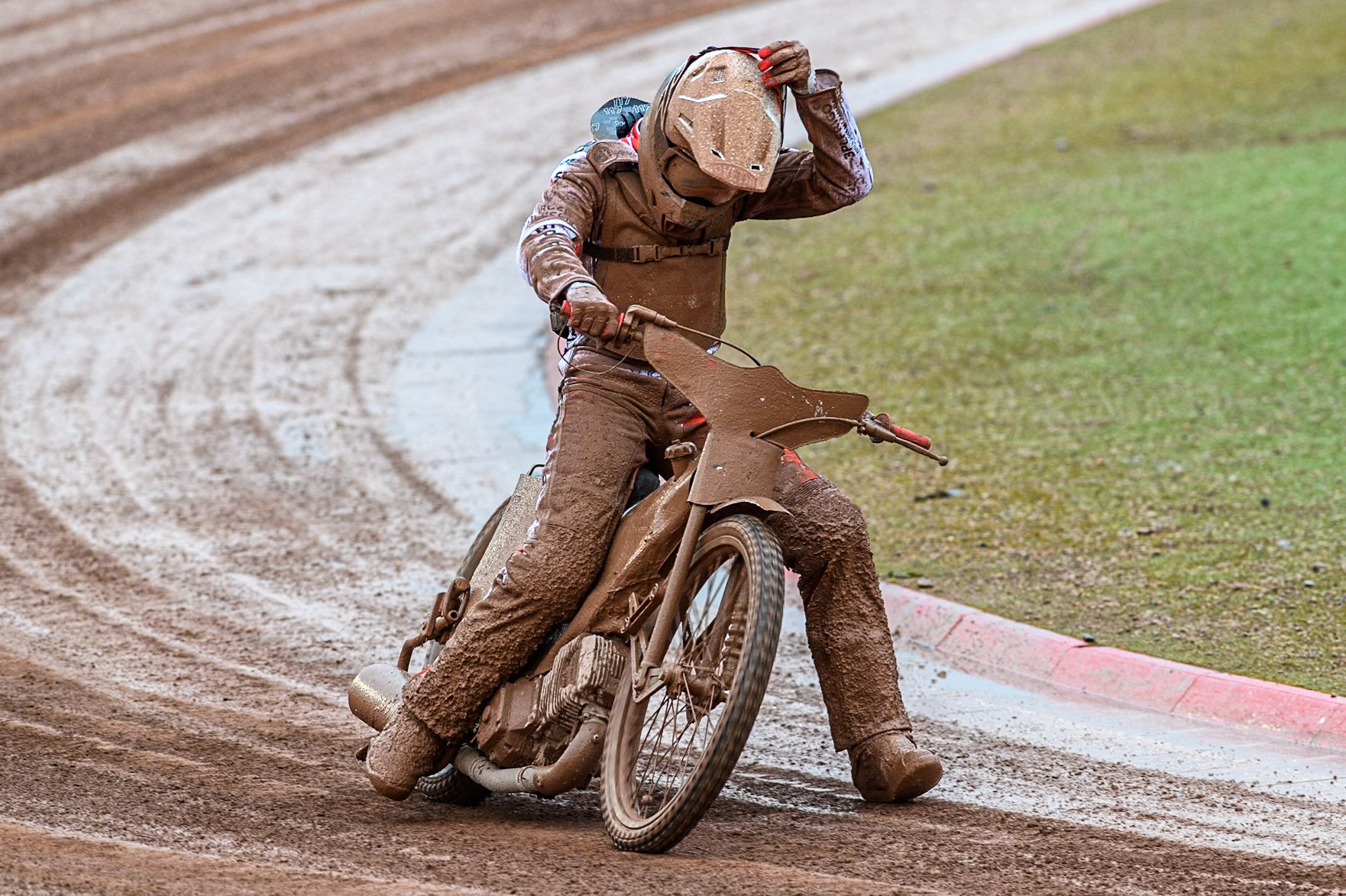 Jesper Knudsen of Denmark pulls up with machine trouble as he tries to remove his mud covered goggles during the Monster Energy FIM Speedway of Nations 2 (Under 21) Final at the National Speedway Stadium, Manchester on Friday 12th July 2024. (Photo: Ian Charles | MI News)