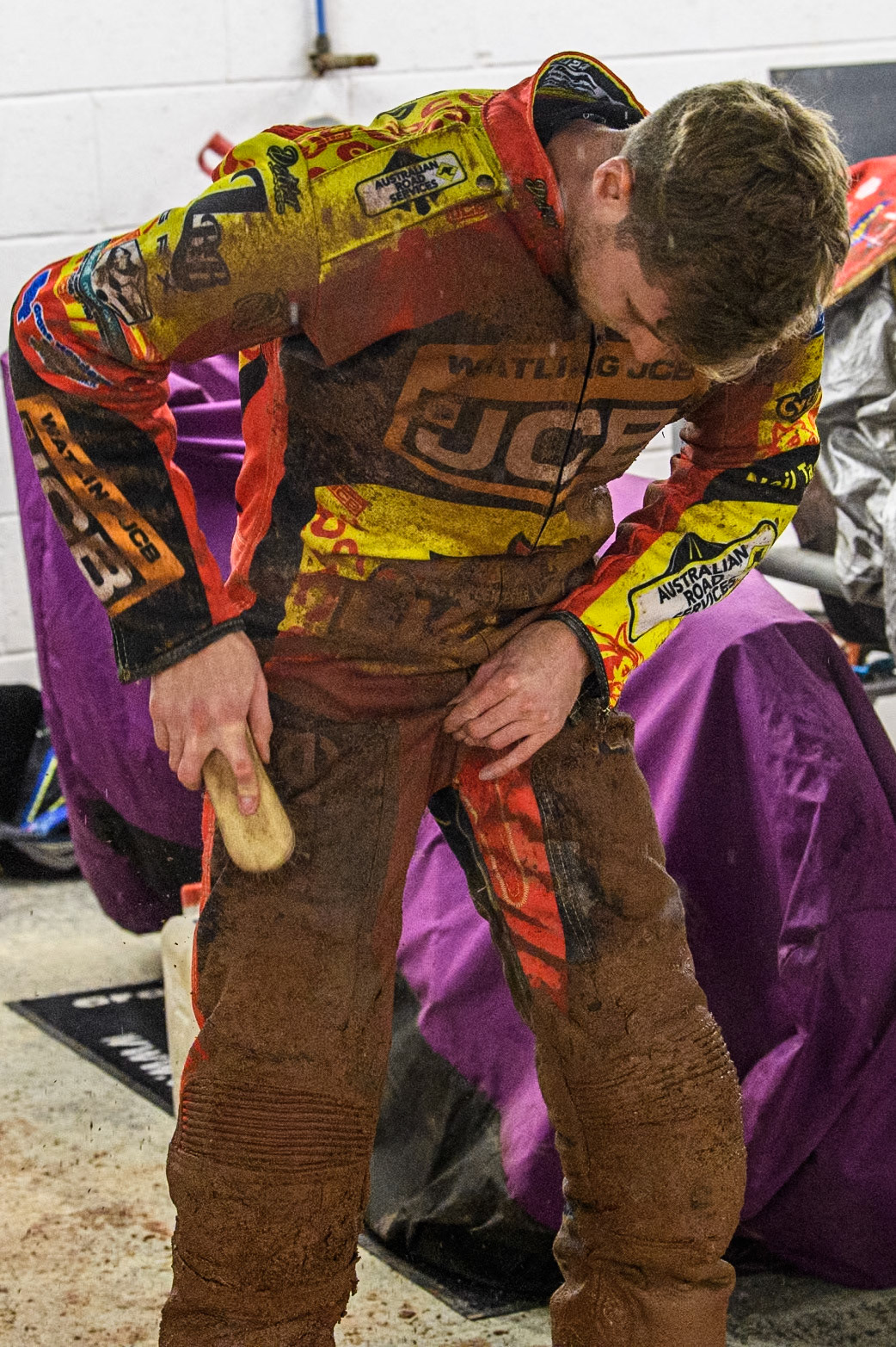 Ryan Douglas of Leicester Lions tries to brush the mud off his kevlars during the Rowe Motor Oil Premiership match between Belle Vue Aces and Leicester Lions at the National Speedway Stadium, Manchester on Saturday 6th April 2024. (Photo: Ian Charles | MI News)