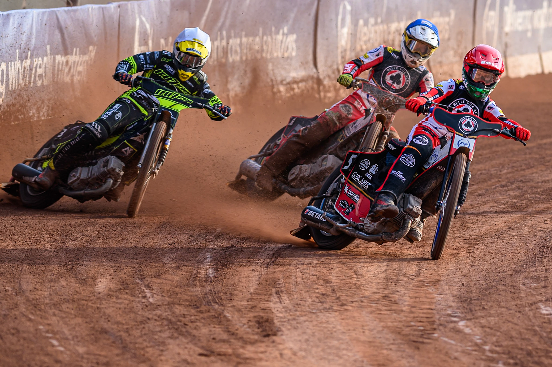 Belle Vue Aces' Brady Kurtz  in Red leading Ipswich Witches' Adam Ellis  in White and Belle Vue Aces' Tate Zischke in Blue during the Rowe Motor Oil Premiership match between Belle Vue Aces and Ipswich Witches at the National Speedway Stadium, Manchester on Monday 30th June 2025. (Photo: Ian Charles | MI News)