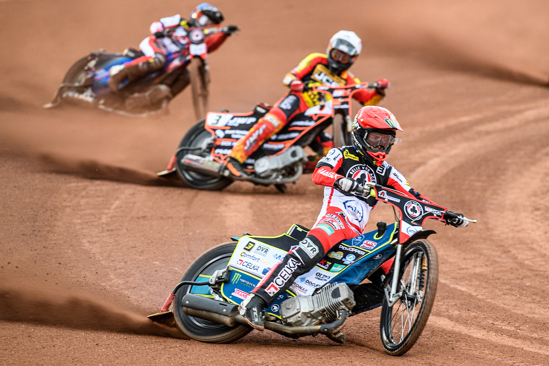 Belle Vue Aces' Jaimon Lidsey in Red leading Leicester Lions' Sam Masters in White and Belle Vue Aces' Ben Cook in Blue during the Rowe Motor Oil Premiership match between Belle Vue Aces and Leicester Lions at the National Speedway Stadium, Manchester on Monday 24th June 2024. (Photo: Ian Charles | MI News)