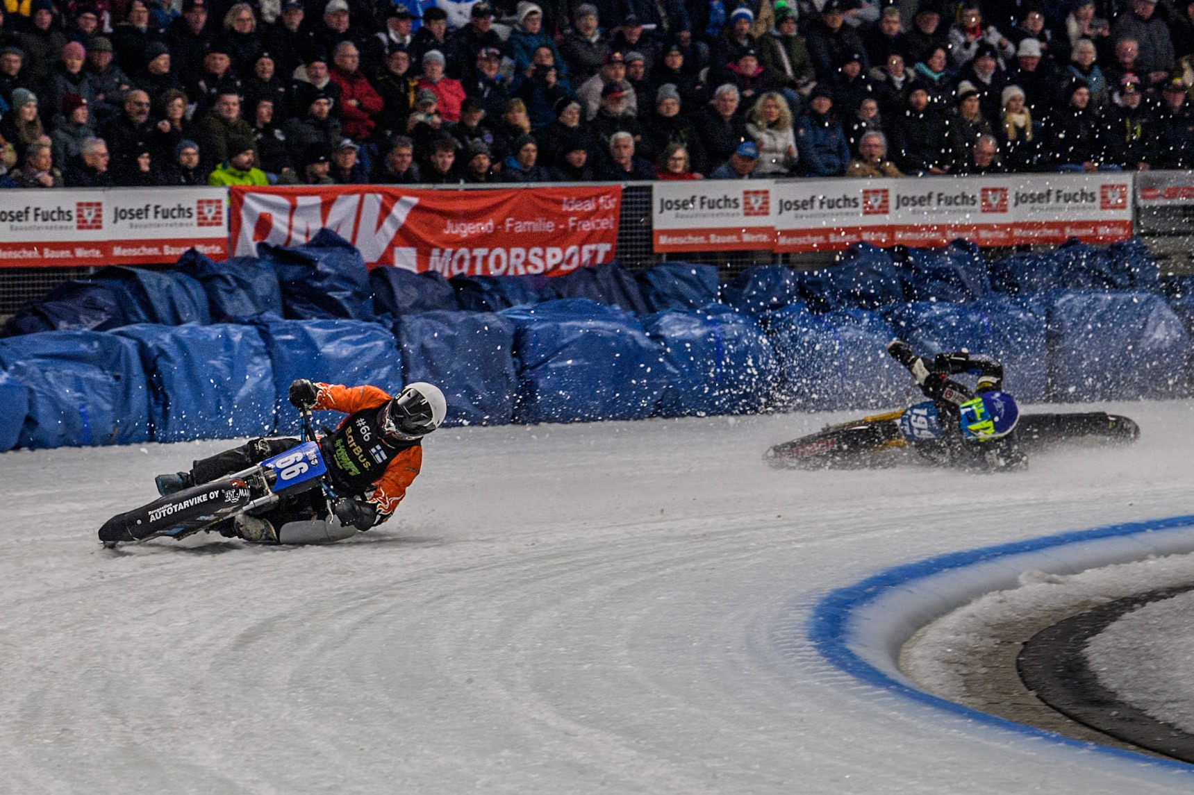 Finland's Aki Ala-Riihimäki (66) (White) leads  as Sweden's Martin Haarahiltunen (199)  (Blue) crashes out during the FIM Ice Speedway Gladiators World Championship Final 2 at the Max-Aicher-Arena, Inzell on Sunday 24 March 2024. (Photo: Ian Charles | MI News)
