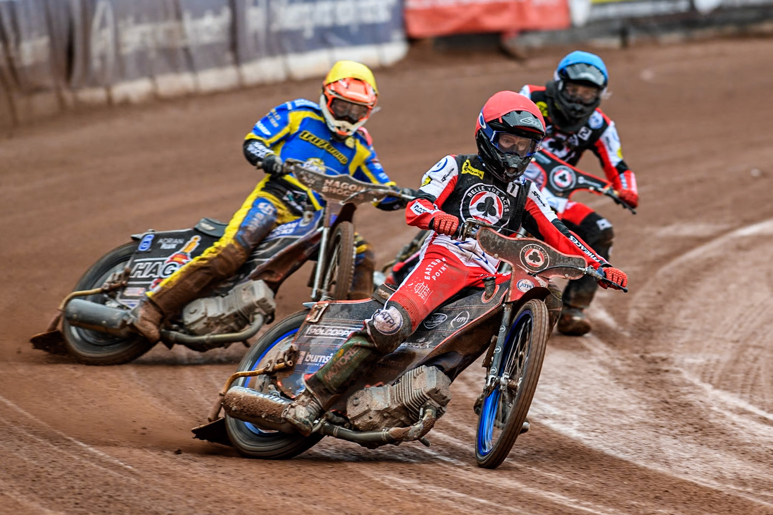 Belle Vue ATPI Aces Brady Kurtz (Red) leads  Sheffield Tigers' Jason Edwards (Yellow) and Belle Vue ATPI Aces Norick Blodorn (Blue) during the Rowe Motor Oil Premiership KO Cup Quarter Final 1st Leg between Belle Vue Aces and Sheffield Tigers at the National Speedway Stadium, Manchester on Monday 1st April 2024. (Photo: Ian Charles | MI News)