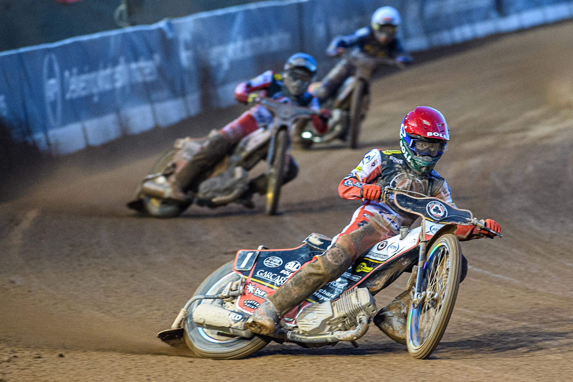 Brady Kurtz of Belle Vue Aces in Red leading Norick Blödorn of Belle Vue Aces in Blue and Jan Kvech of Kings Lynn Stars in White during the Rowe Motor Oil Premiership match between Belle Vue Aces and King's Lynn Stars at the National Speedway Stadium, Manchester on Monday 5th April 2025. (Photo: Ian Charles | MI News)