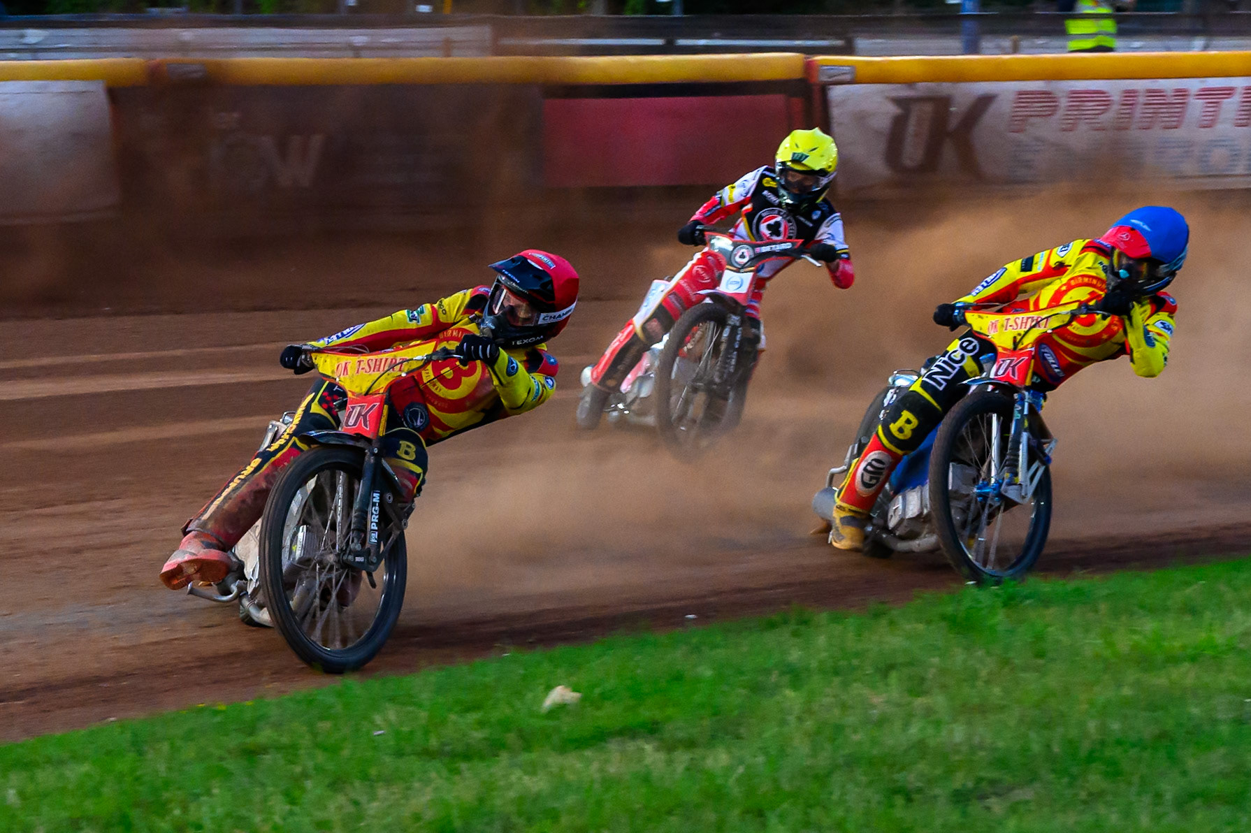 Birmingham Brummies' Tobias Musielak  in Red and Birmingham Brummies' Matej Zagar  in Blue leading ‘Belle Vue Aces' Dan Bewley  in Yellow during the Rowe Motor Oil Premiership match between Birmingham Brummies and Belle Vue Aces at Perry Barr Stadium, Birmingham on Monday 28th July 2025. (Photo: Ian Charles | MI News)