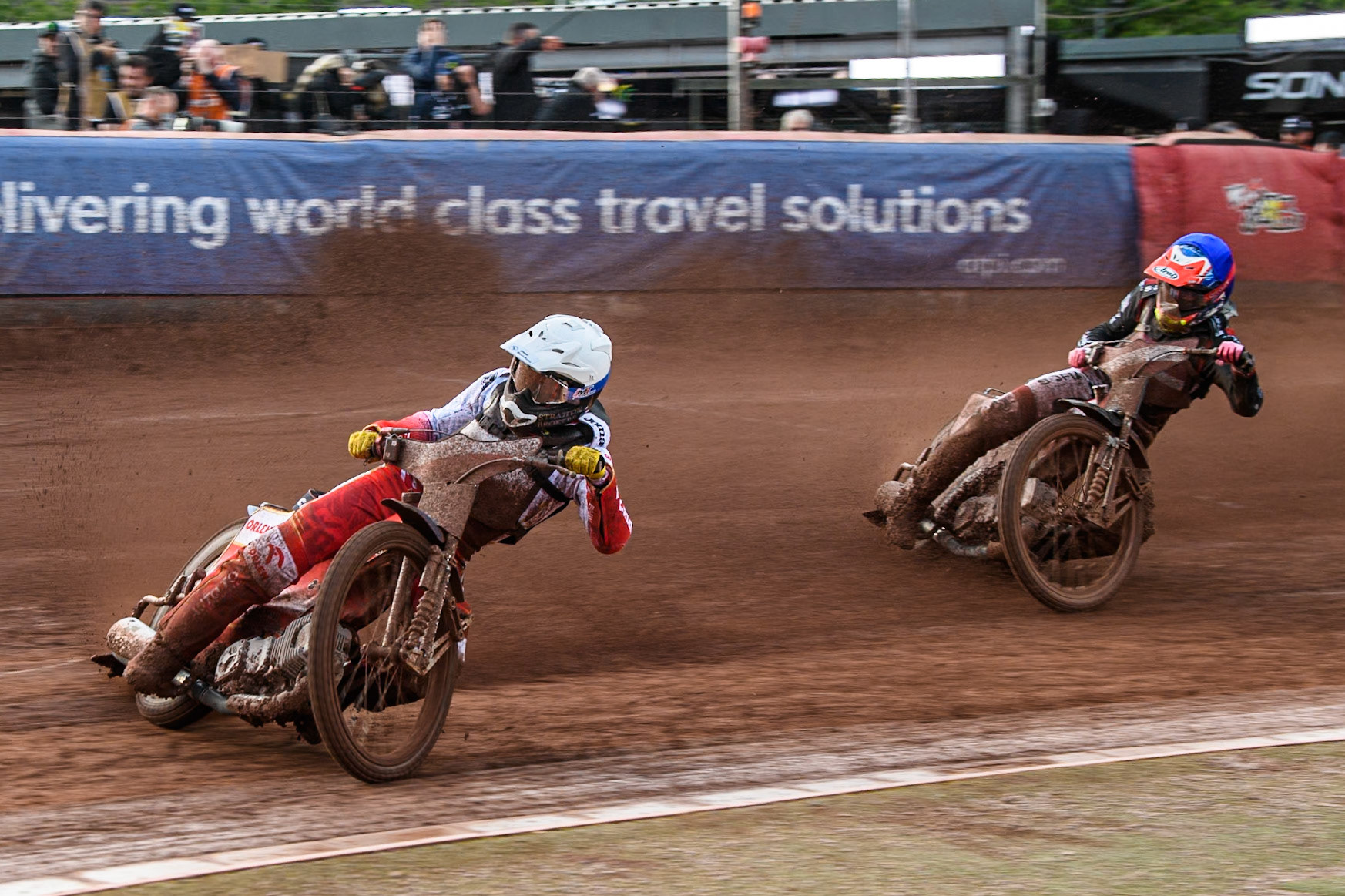 Dominik Kubera of Poland in White leading Daniils Kolodinskis of Latvia in Blue during the Monster Energy FIM Speedway of Nation Final at the National Speedway Stadium, Manchester on Saturday 13th July 2024. (Photo: Ian Charles | MI News)