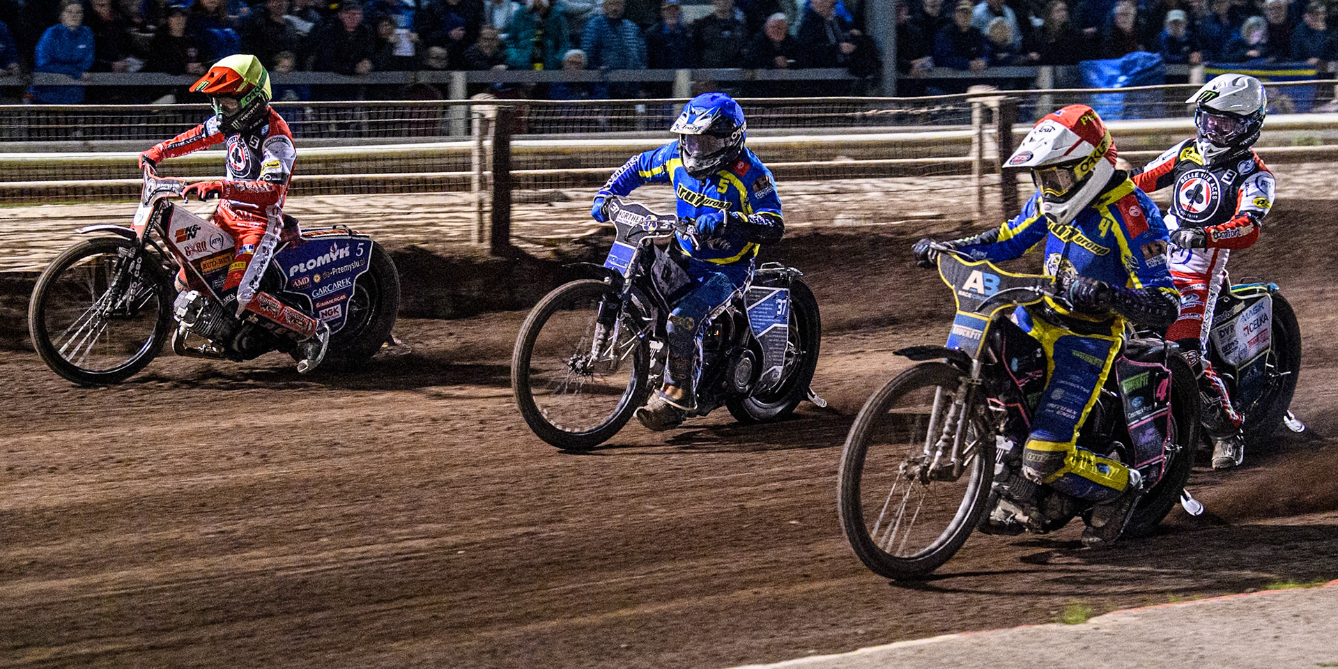 Sheffield Tigers' Josh Pickering  in Red and Sheffield Tigers' Guest Rider Chris Harris  in Blue rides inside Belle Vue Aces' Dan Bewley  in Yellow with Belle Vue Aces' Jaimon Lidsey  in White behind during the Rowe Motor Oil Premiership Play Off Semi Final 2nd leg between Sheffield Tigers and Belle Vue Aces at Owlerton Stadium, Sheffield on Thursday 19th September 2024. (Photo: Ian Charles | MI News)