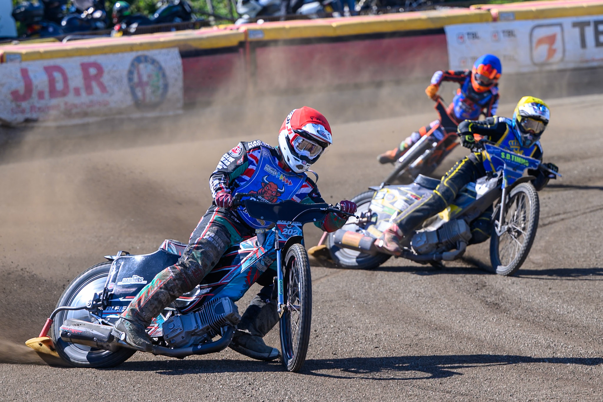 Alfie Bowtell of Buxton Bulls in Red leading Dayle Wood of Edinburgh Monarchs Academy in Yellow and Jack Smith of Buxton Bulls in Blue during the WSRA National Development League match between Buxton Bulls and Edinburgh Monarchs Academy at Hi-Edge Speedway, Buxton on Sunday 14th June 2026. (Photo: Ian Charles | MI News)