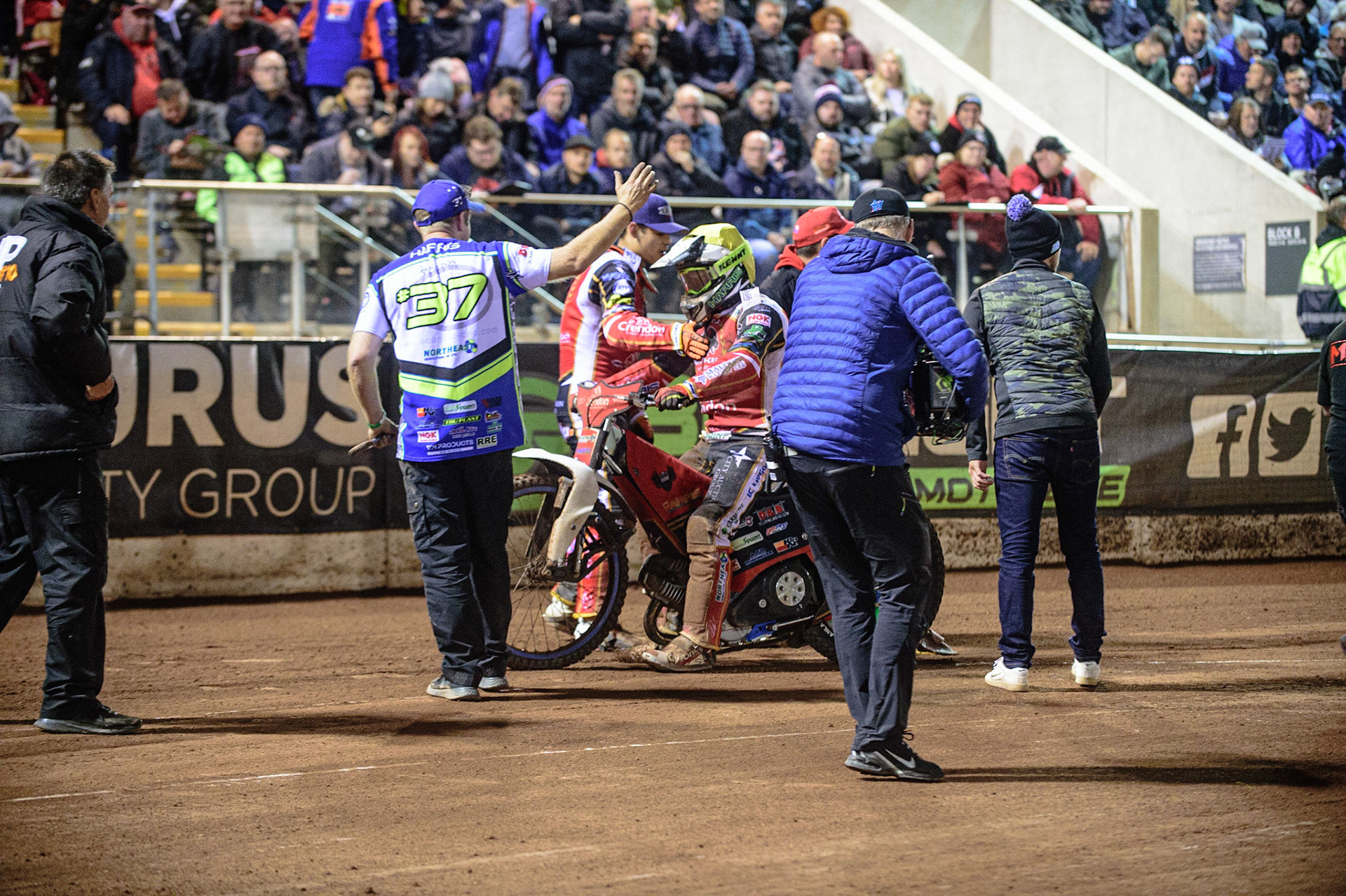 MANCHESTER, UK. OCT 11TH  Panthers riders and mechanics congratulate Chris Harris  on his win during the SGB Premiership Grand Final 1st Leg between Belle Vue Aces and Peterborough Panthers at the National Speedway Stadium, Manchester on Monday 11th October 2021. (Credit: Ian Charles | MI News)