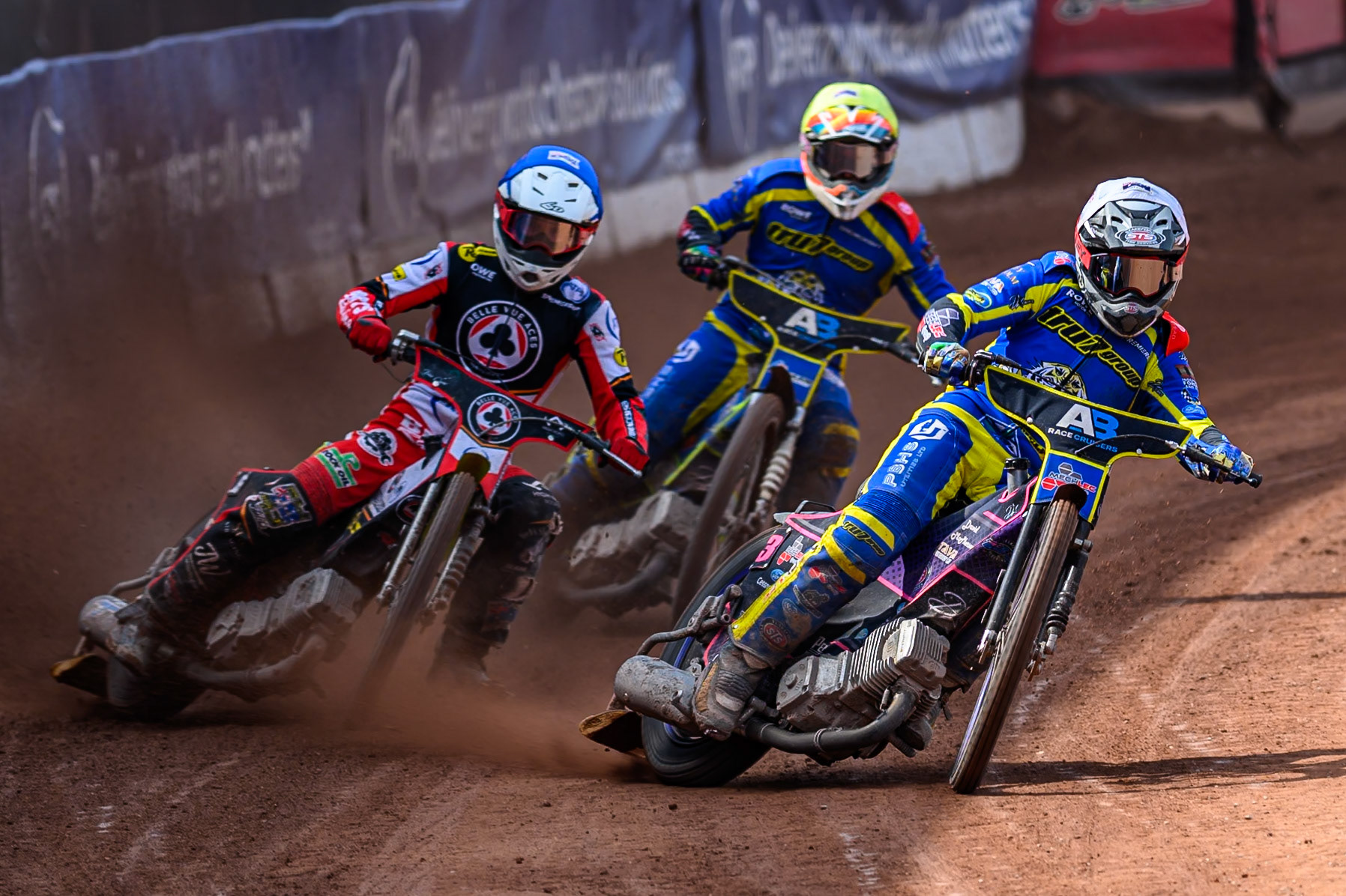Josh Pickering of Sheffield Tigers  in White rides inside Tate Zischke of Belle Vue Aces  in Blue with Nick Morris of Sheffield Tigers  behind during the Rowe Motor Oil Premiership match between Belle Vue Aces and Sheffield Tigers at the National Speedway Stadium, Manchester on Monday 25th August 2025. (Photo: Ian Charles | MI News)