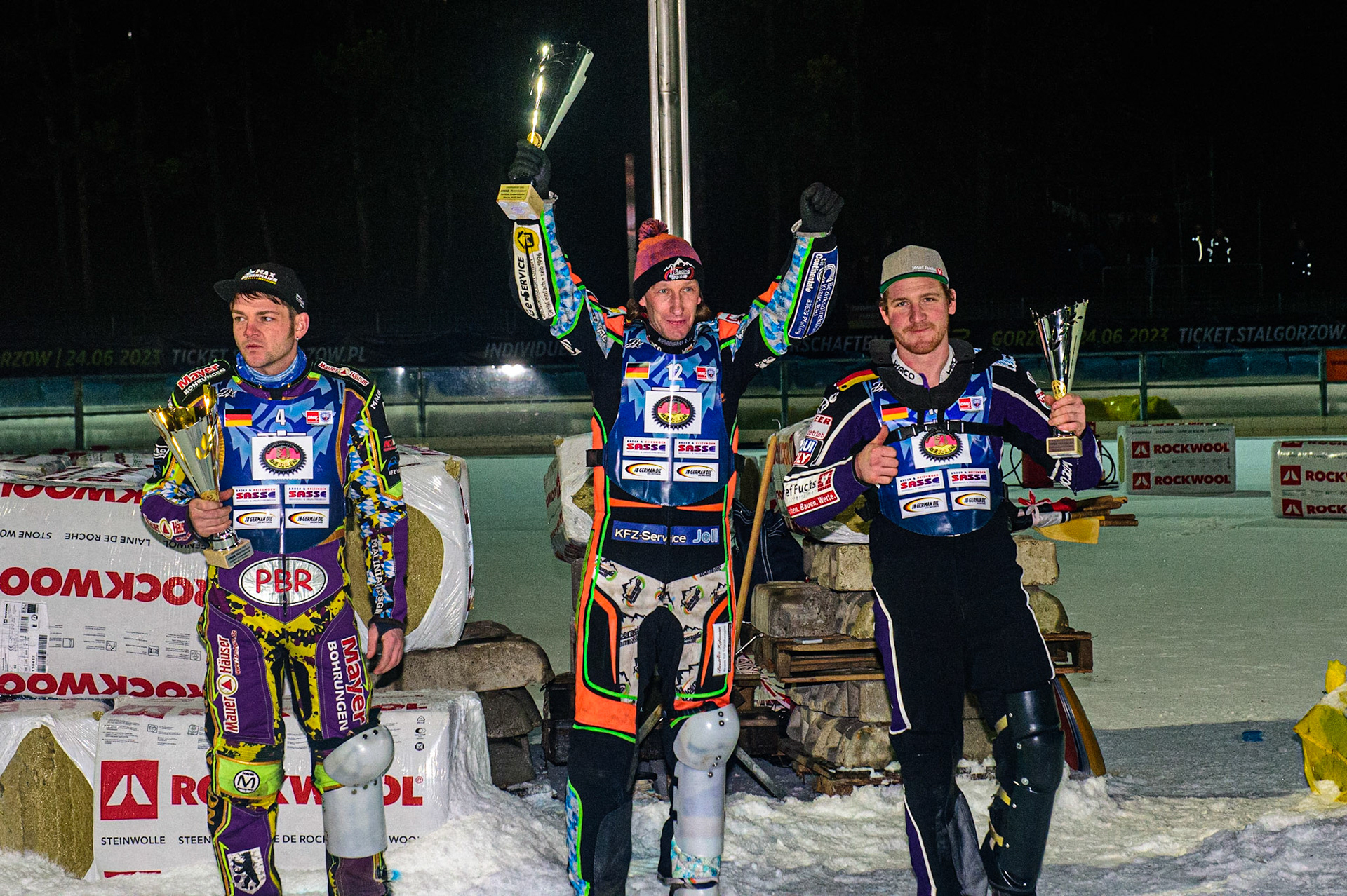 Markus Jell celebrates his win with Max Neidermaier (left) and Benedikt Monn (right) during the German Individual Ice Speedway Championship at Horst-Dohm-Eisstadion, Berlin on Friday 3rd March 2023. (Photo: Ian Charles | MI News)