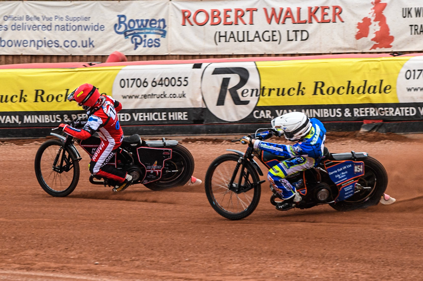 Oxford Chargers' Luke Killeen  in White chases Belle Vue Colts' Sam Hagon  in Red during the WSRA National Development League match between Belle Vue Colts and Oxford Chargers at the National Speedway Stadium, Manchester on Friday 2nd August 2024. (Photo: Ian Charles | MI News)