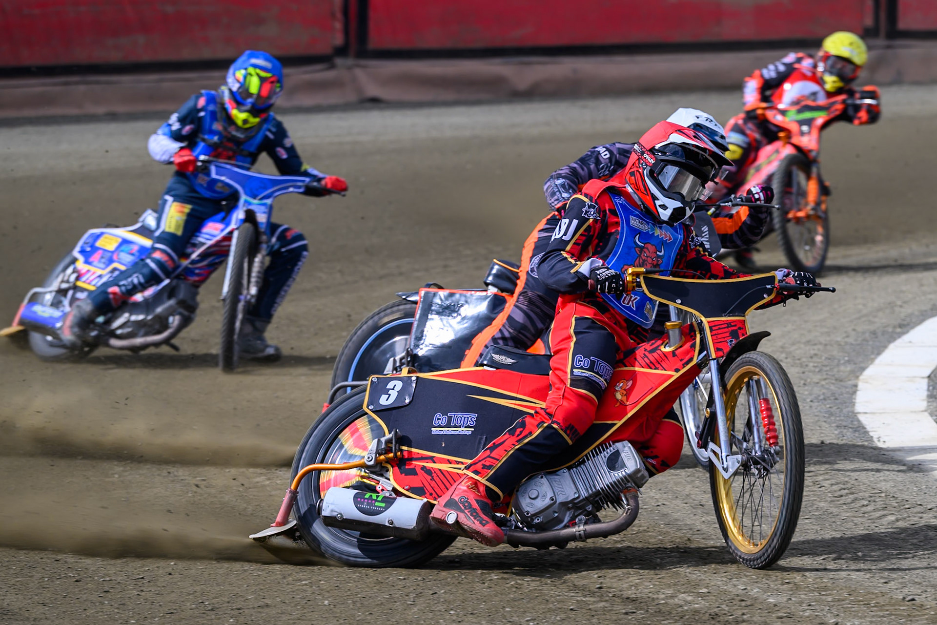 Luke Harris of Buxton Bulls   in Red leading Jack Roberts of NDL Nomads  in White with Jamie Etherington of Buxton Bulls in Blue and Alex Spooner of NDL Nomads   in Yellow behind during the  Challenge match between Buxton Bulls and NDL Nomads at Hi-Edge Speedway, Buxton on Sunday 19th April 2026. (Photo: Ian Charles | MI News)