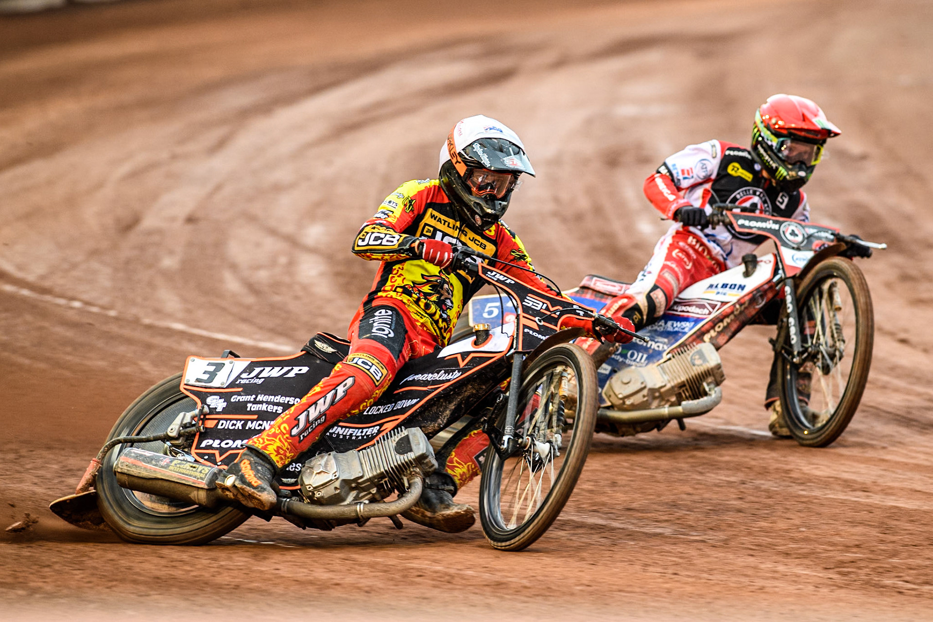 Leicester Lions' Sam Masters in White rides outside Belle Vue Aces' Dan Bewley in Red during the Rowe Motor Oil Premiership match between Belle Vue Aces and Leicester Lions at the National Speedway Stadium, Manchester on Monday 24th June 2024. (Photo: Ian Charles | MI News)