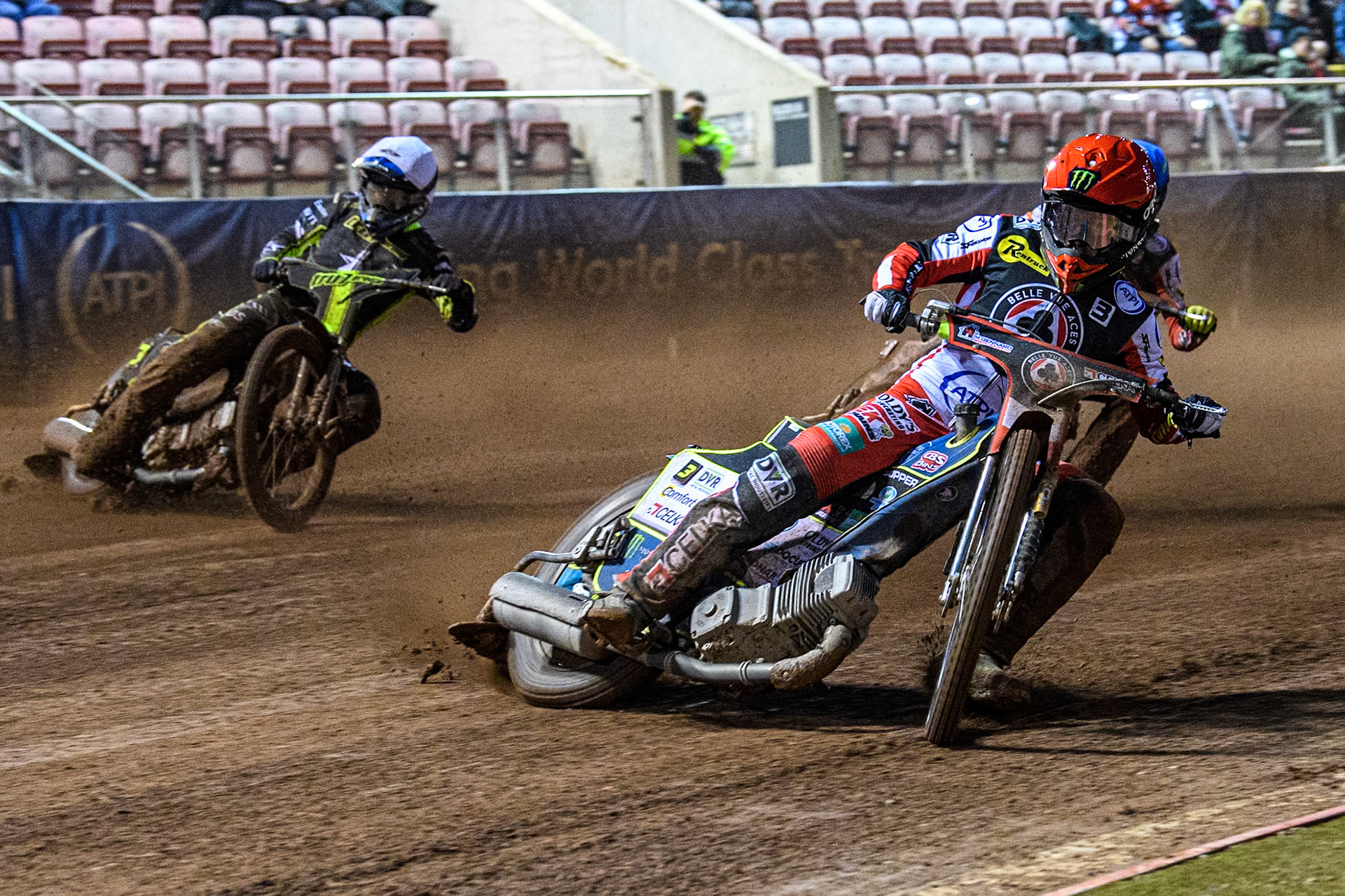 Belle Vue Aces' Jaimon Lidsey in Red leading Ipswich Witches' Adam Ellis in White and Belle Vue Aces' Connor Bailey in Blue during the Rowe Motor Oil Premiership match between Belle Vue Aces and Ipswich Witches at the National Speedway Stadium, Manchester on Monday 22nd April 2024. (Photo: Ian Charles | MI News)