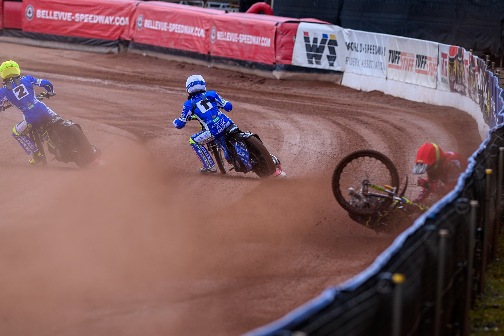 Belle Vue Colts' William Cairns falls whilst trying to pass Oxford Chargers' Jody Scott  in White and Oxford Chargers' Jacob Clouting  in Yellow during the WSRA National Development League match between Belle Vue Colts and Oxford Chargers at the National Speedway Stadium, Manchester on Sunday 1st June 2025. (Photo: Ian Charles | MI News)