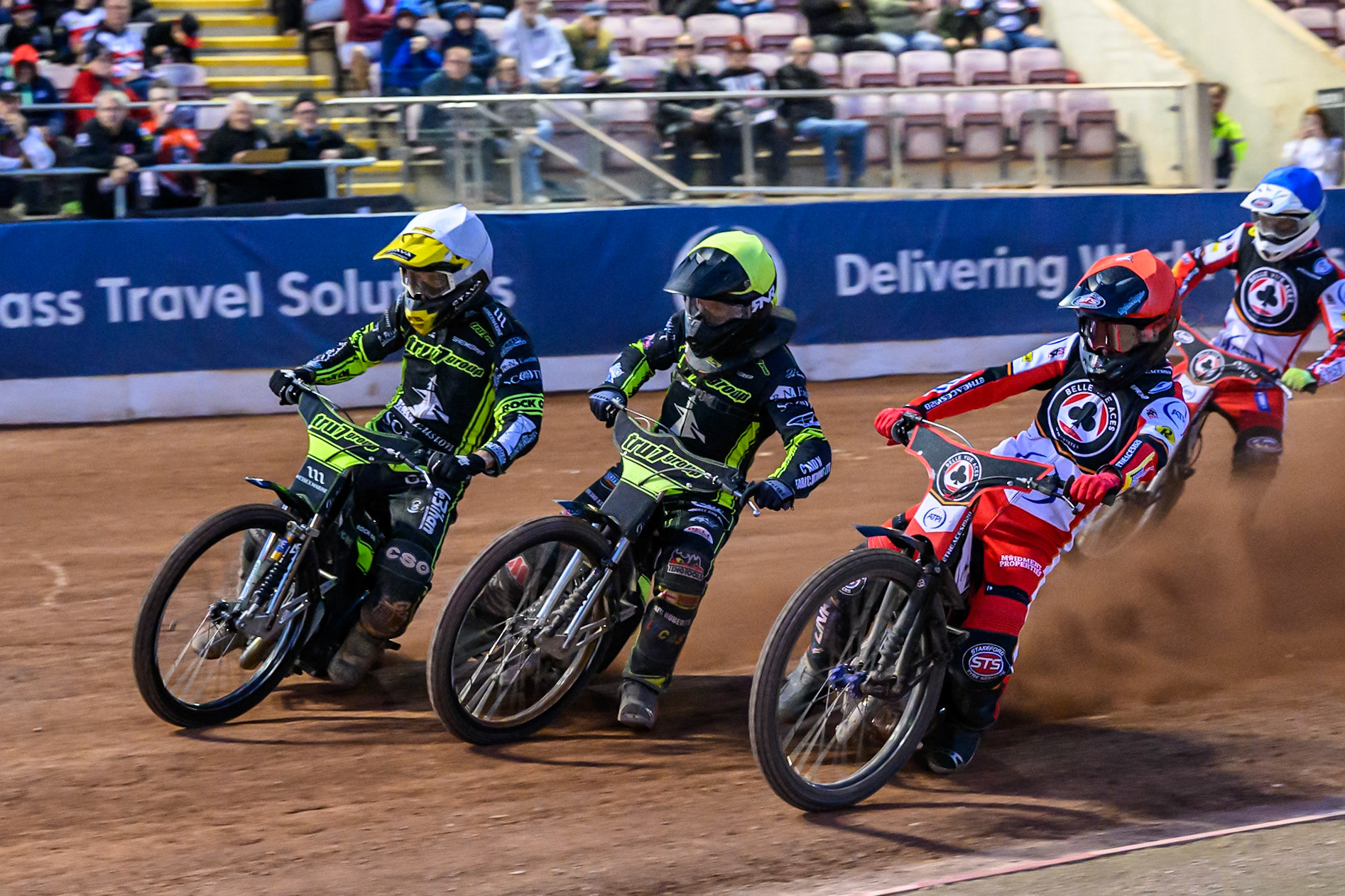 Zach Cook of Belle Vue Aces  in Red on the inside of Dan Thompson of Ipswich Witches  in Yellow and Adam Ellis of Ipswich Witches  in White with Jake Mulford of Belle Vue Aces  in Blue behind during the Rowe Motor Oil Premiership match between Belle Vue Aces and Ipswich Witches at the National Speedway Stadium, Manchester on Monday 4th August 2025. (Photo: Ian Charles | MI News)