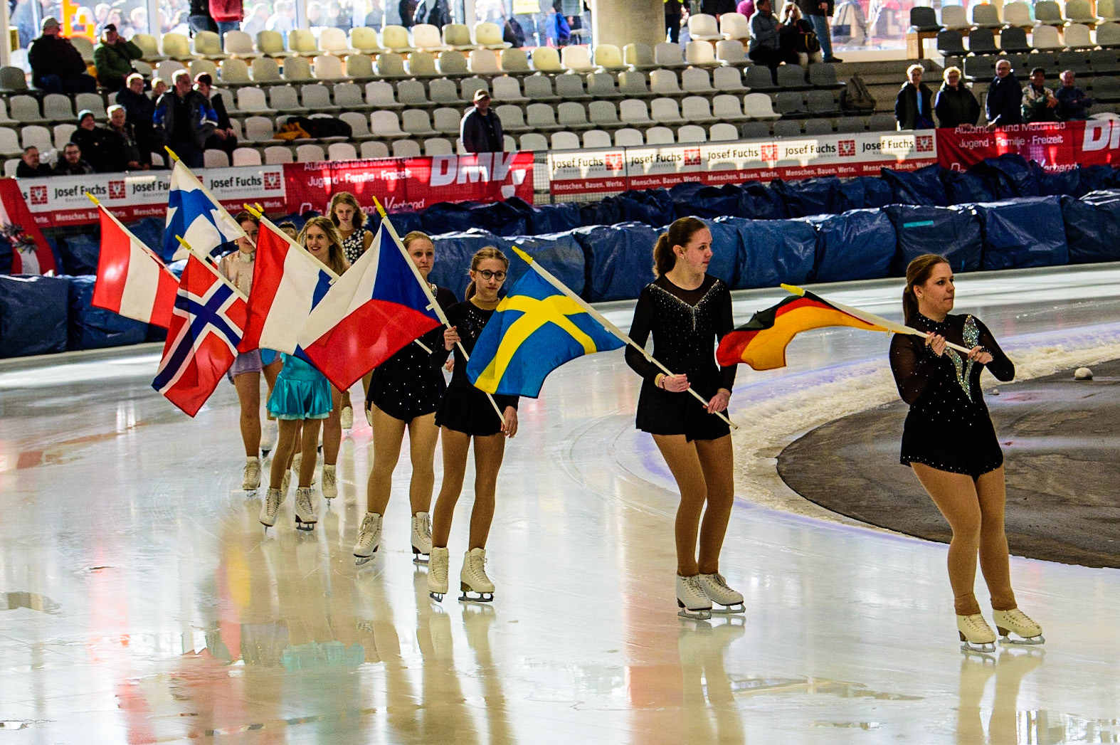The skating club based at the Arena skate around the track with the flags of nations competing during the Ice Speedway Gladiators World Championship Final 1 at Max-Aicher-Arena, Inzell, Germany on Saturday 18th March 2023. (Photo: Ian Charles | MI News)