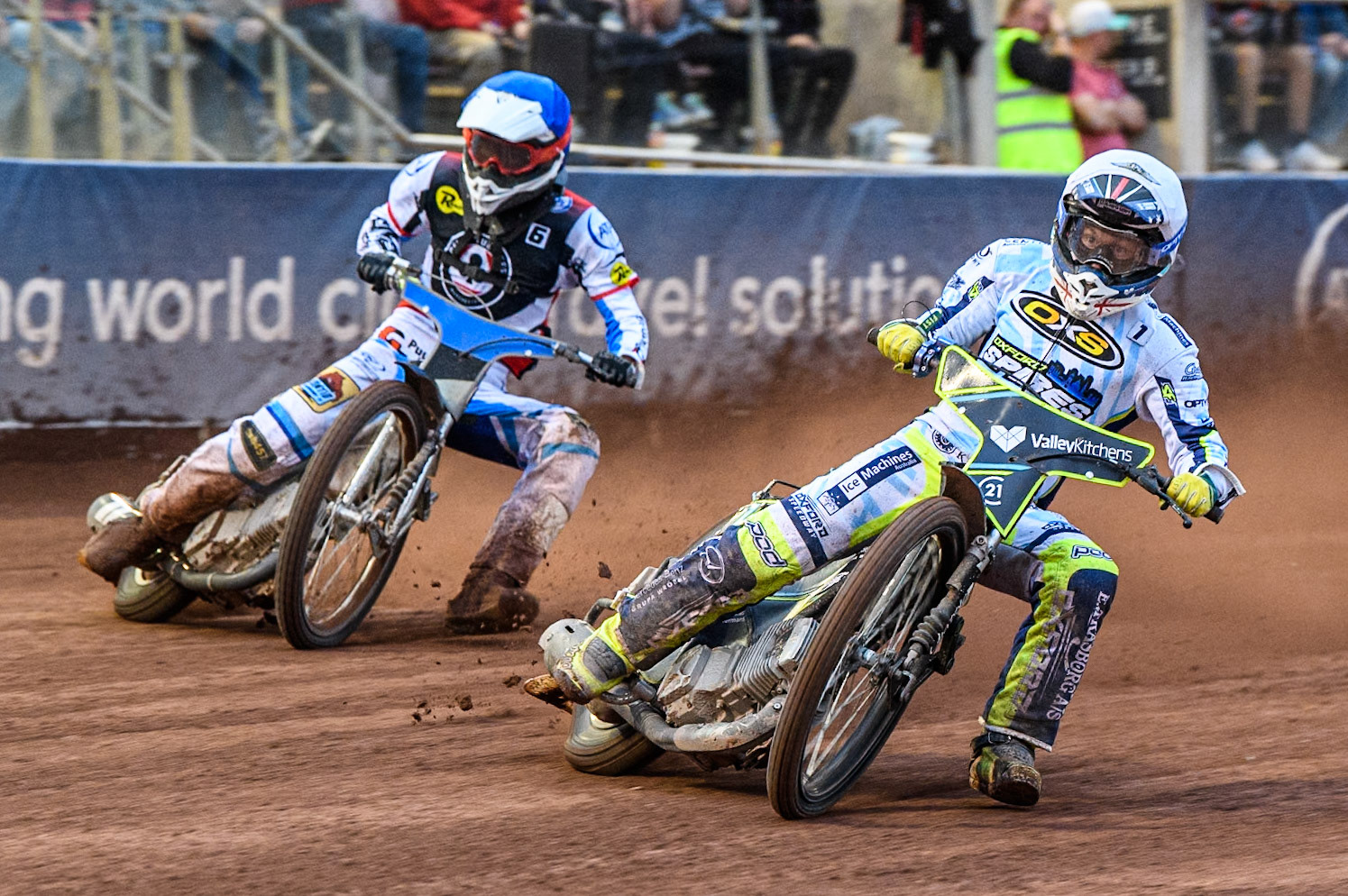 Oxford Spires' Rohan Tungate  in White rides inside Belle Vue Aces' guest Antti Vuolas  in Blue during the Rowe Motor Oil Premiership match between Belle Vue Aces and Oxford Spires at the National Speedway Stadium, Manchester on Monday 22nd July 2024. (Photo: Ian Charles | MI News)