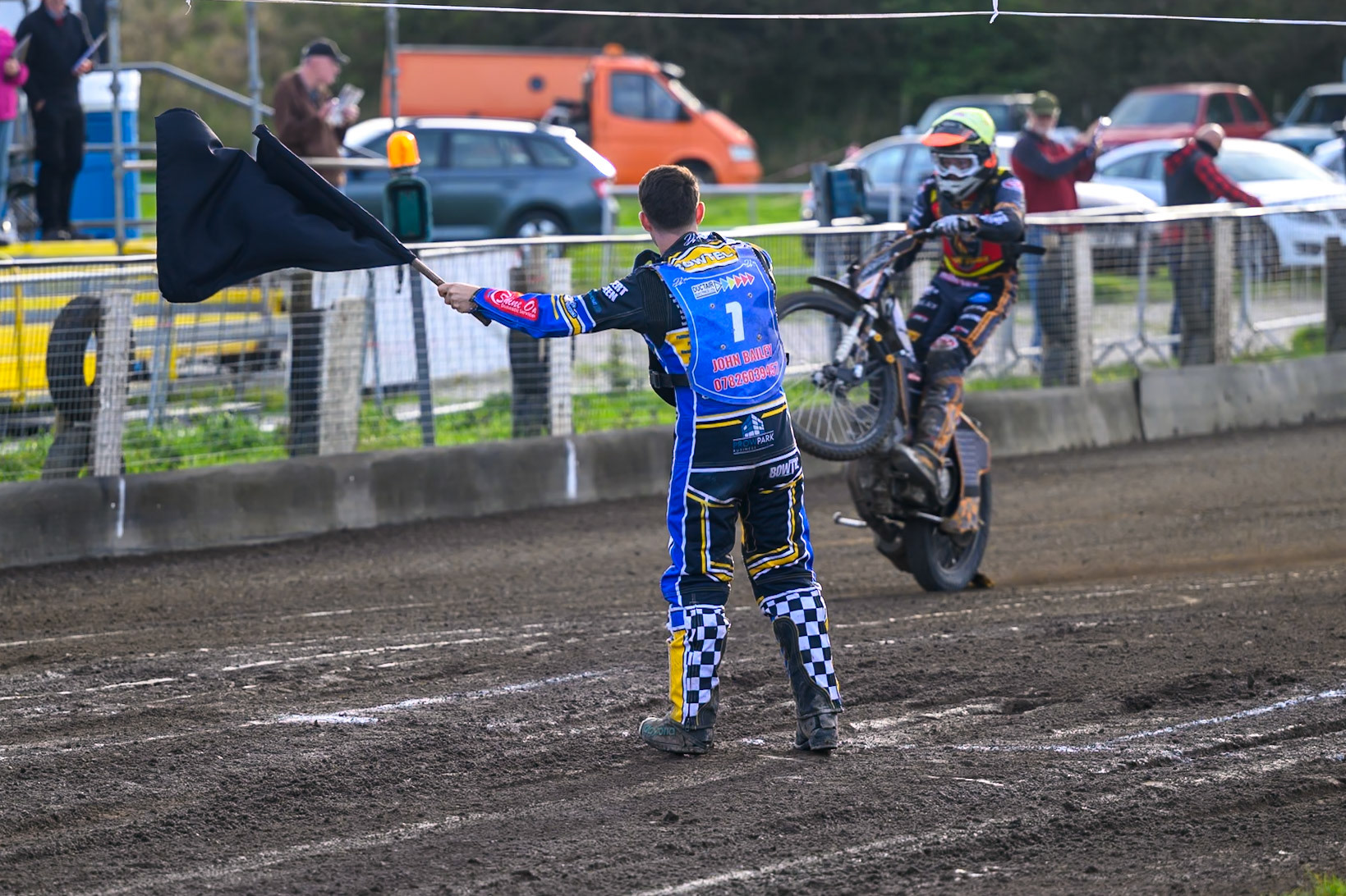 After the final heat, Alfie Bowtell of Buxton Bulls  waves a black exclusion flag at his friend Ryan Ingram of Leicester Lion Cubs  as an end of season joke during the WSRA National Development League match between Buxton Bulls and Leicester Lion Cubs at Hi-Edge Speedway, Buxton on Sunday 4th October 2026. (Photo: Ian Charles | MI News)