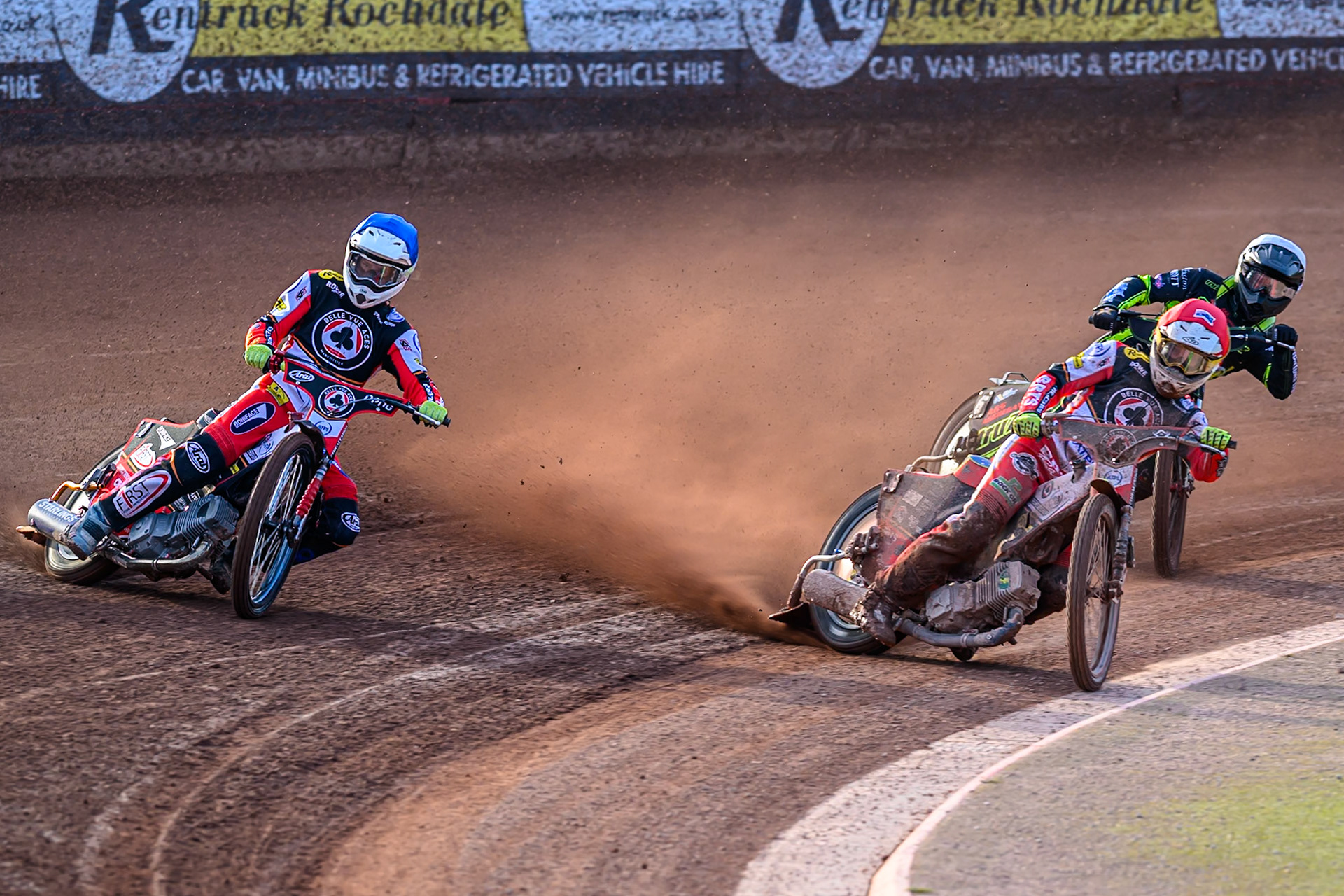Belle Vue Aces' Dan Bewley on the inside of team mate Jake Mulford  in Blue with Ipswich Witches' Dan Thompson  in White behind during the Rowe Motor Oil Premiership match between Belle Vue Aces and Ipswich Witches at the National Speedway Stadium, Manchester on Monday 30th June 2025. (Photo: Ian Charles | MI News)
